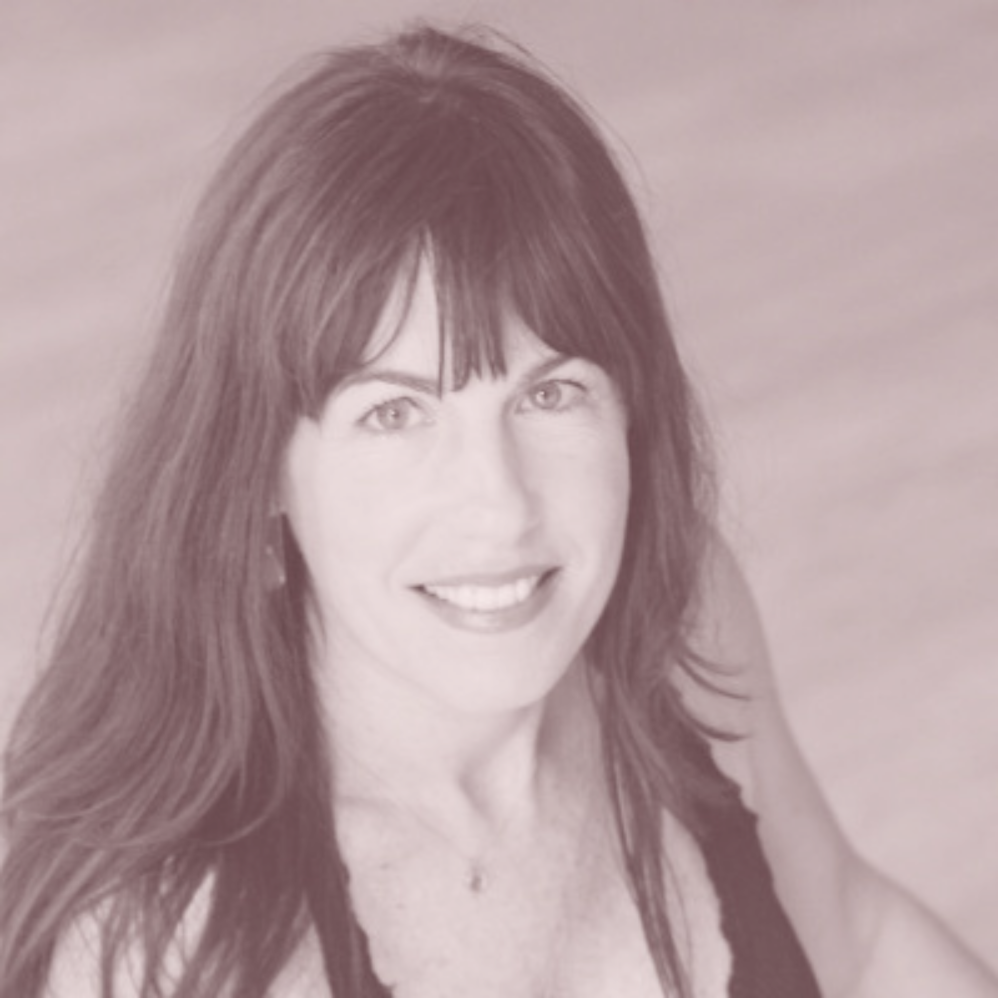 Headshot of a woman with long dark hair and bangs, smiling and looking at the camera, wearing a sleeveless top.
