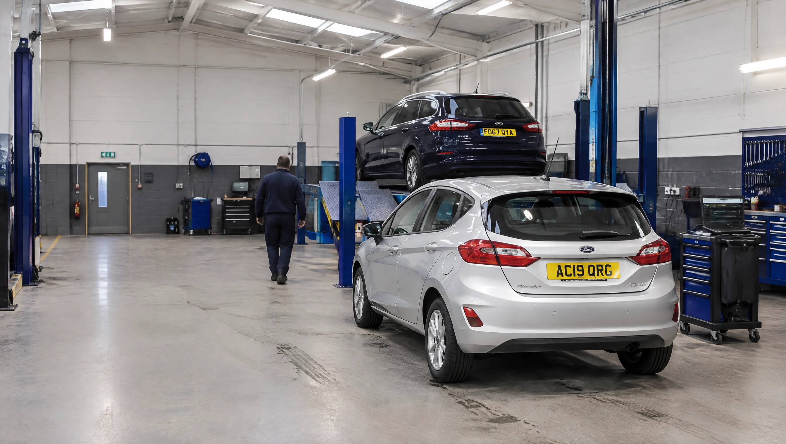 Illustrative image of vehicle service bays in a modern independent garage.