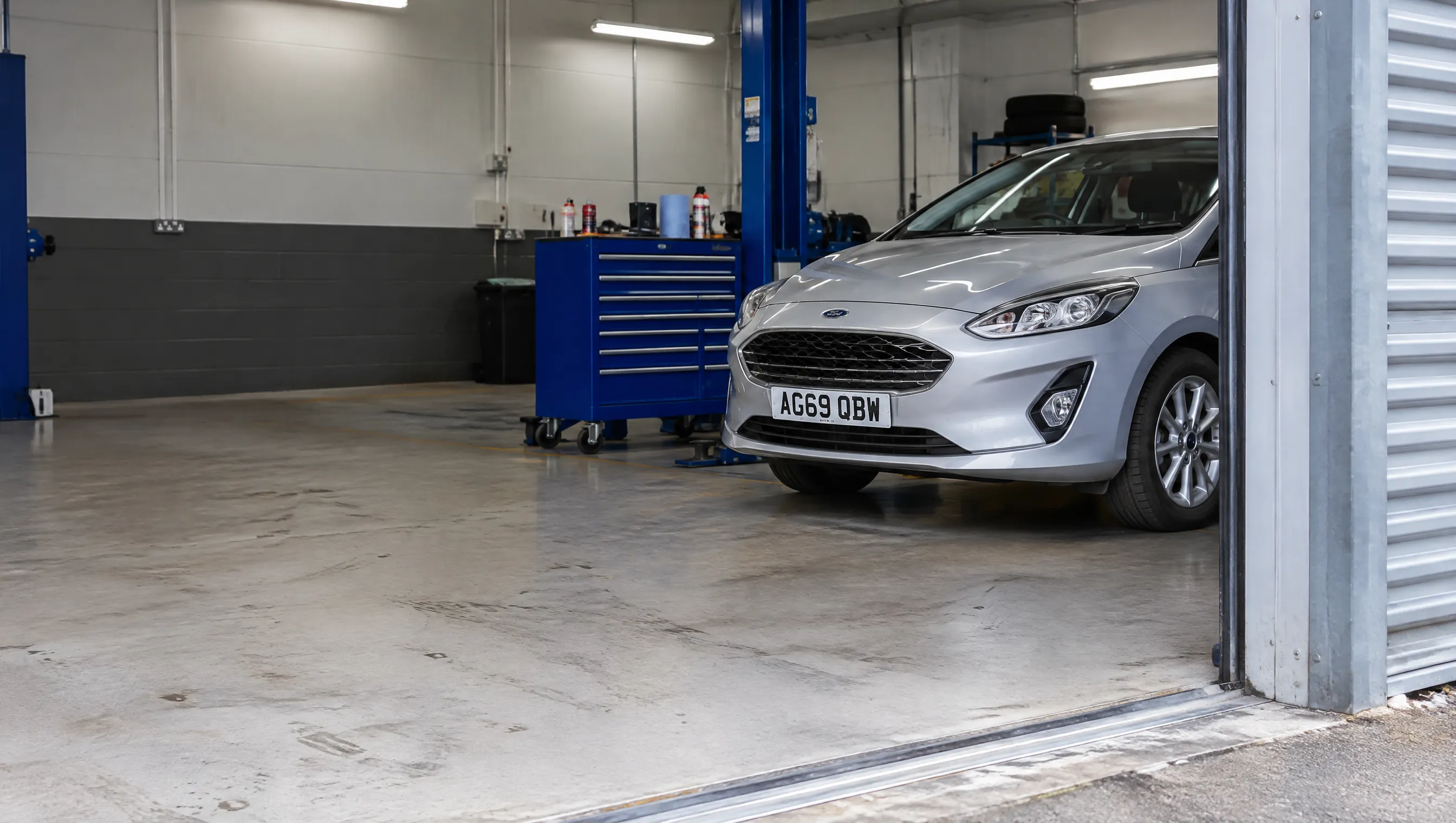 Illustrative detail of a modern vehicle workshop entrance.