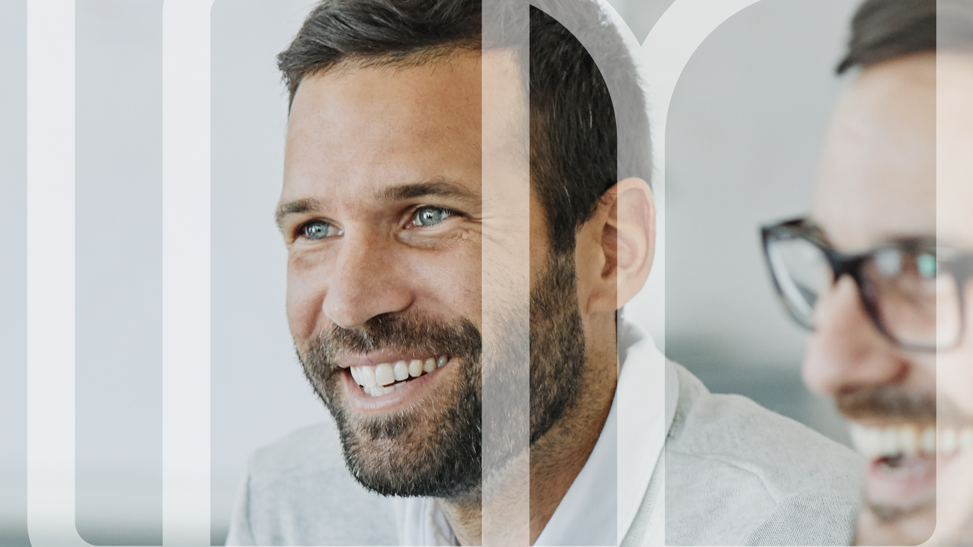 Smiling professional looking toward the camera in a modern office