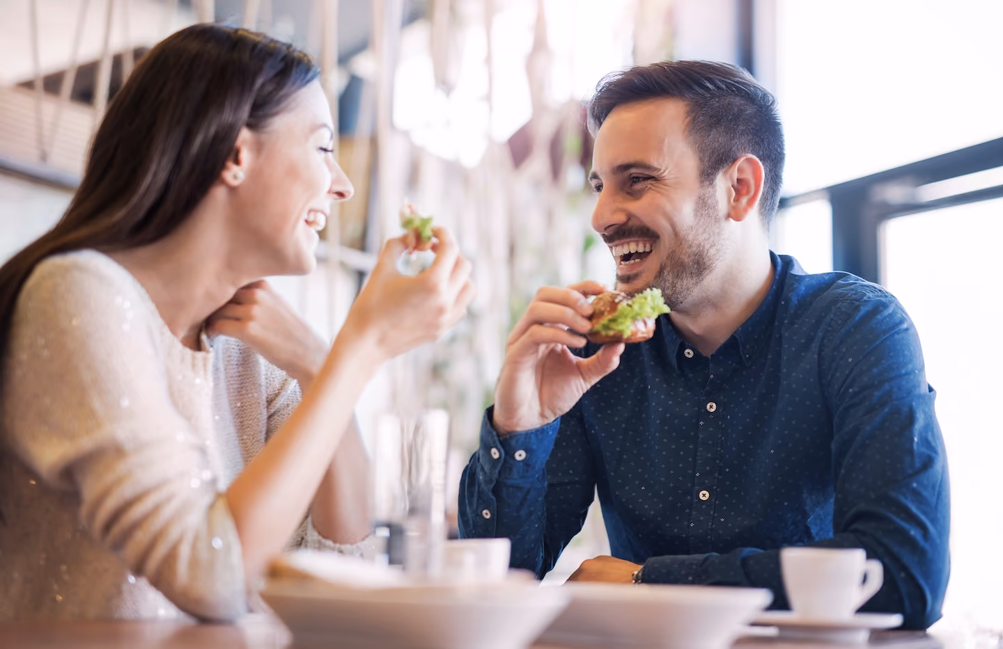 Couple eating sandwiches