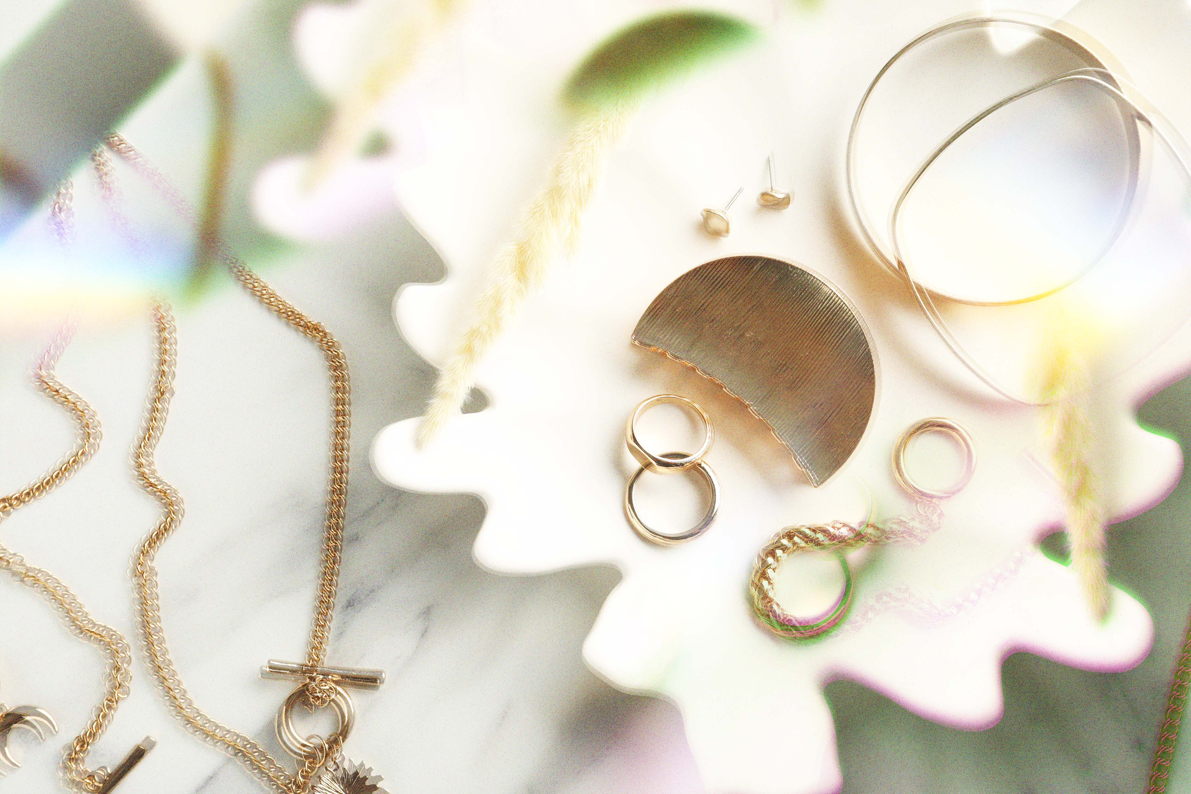 Gold jewelry arranged on a white plate
