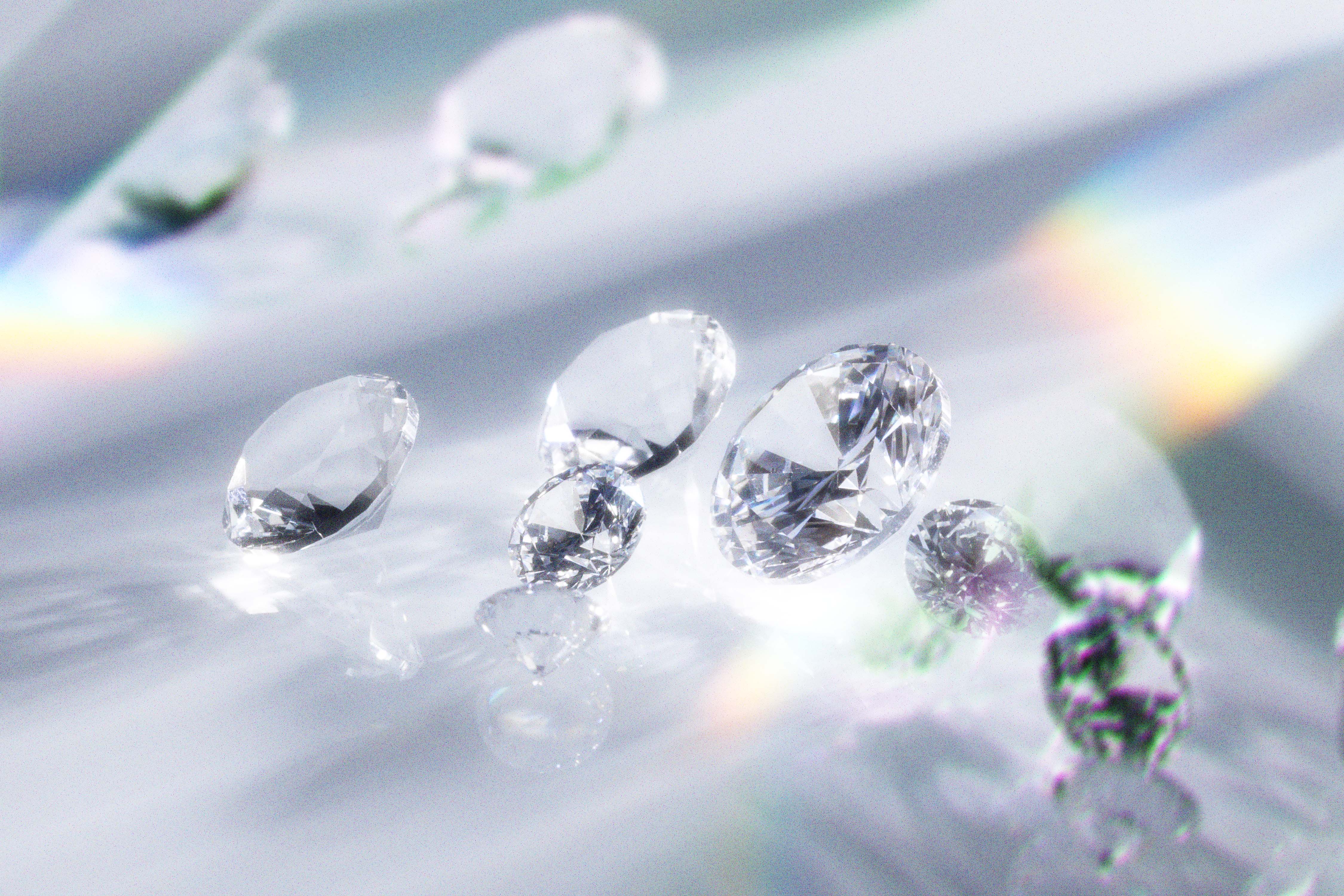 Loose round diamonds on a pale surface