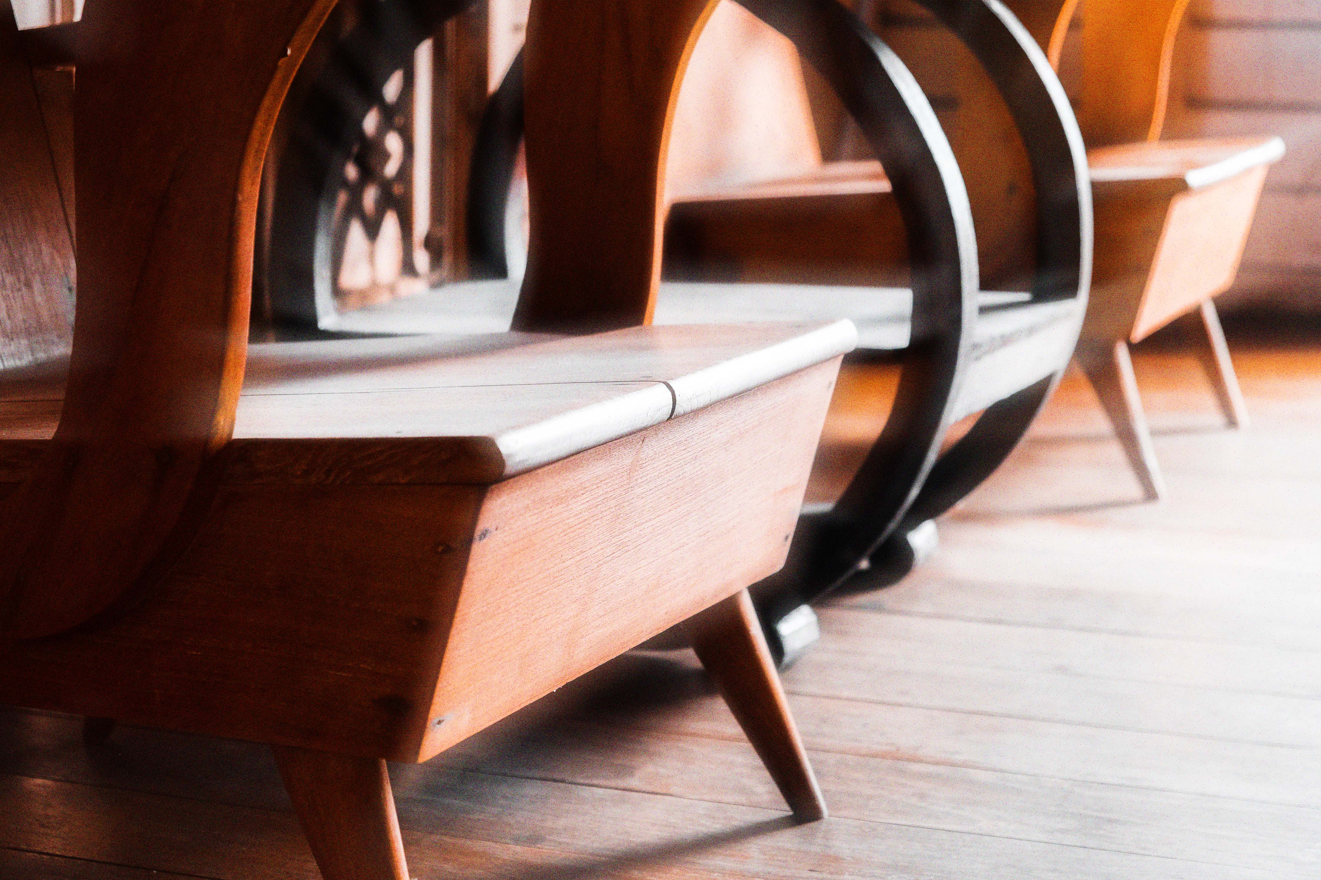 Row of sculptural wooden chairs
