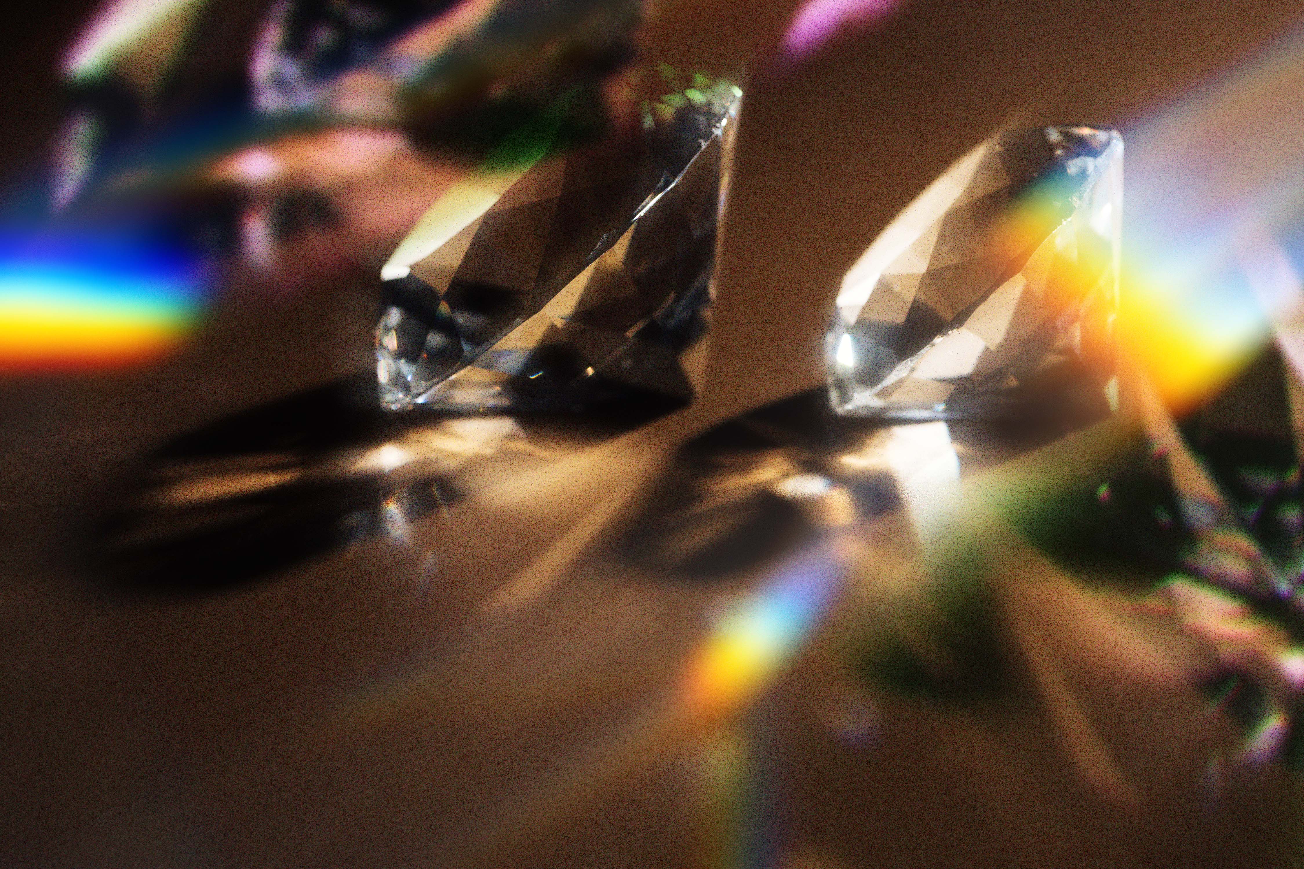 Two diamonds on a dark reflective surface