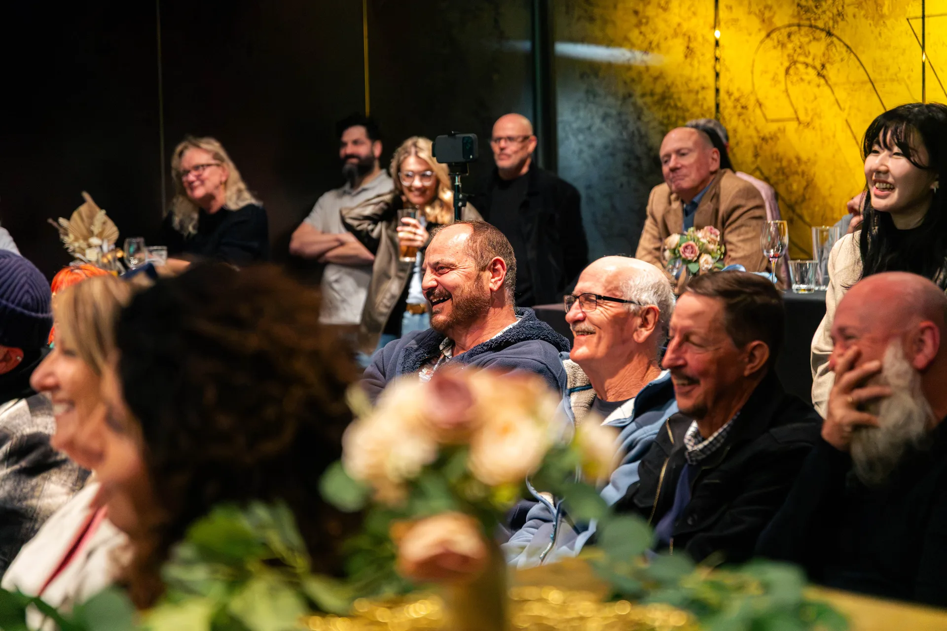 Guests smiling in a dimly lit Perth venue during an event filmed by Growth Concept Media, Western Australia. Guests smiling in a dimly lit Perth venue during an event filmed by Growth Concept Media, Western Australia.
