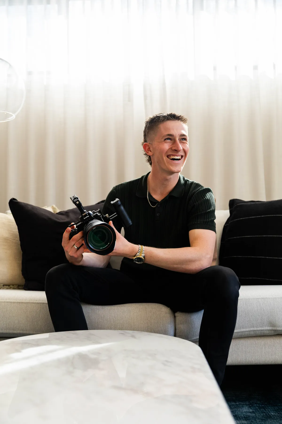 Keoni Upton laughing with a cinema camera during a Perth brand portrait session.