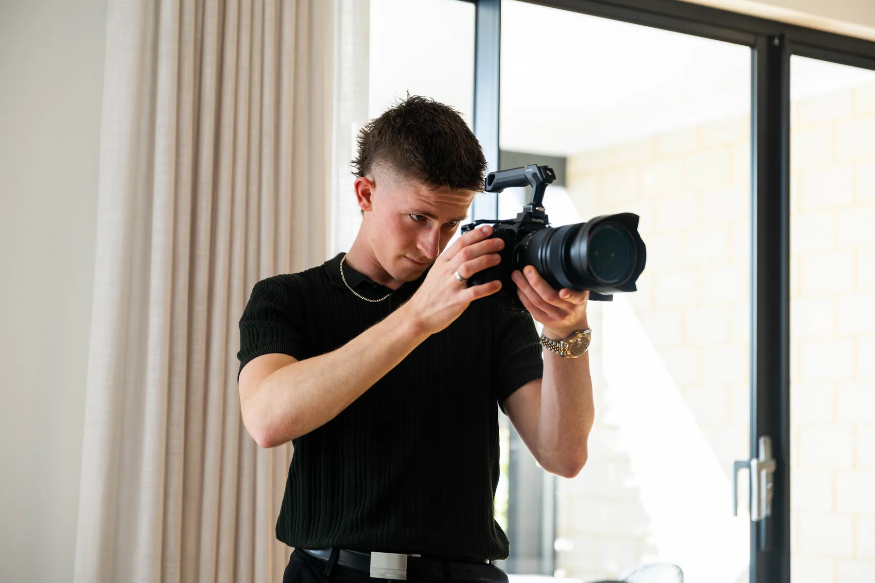 Keoni filming with a cinema camera.