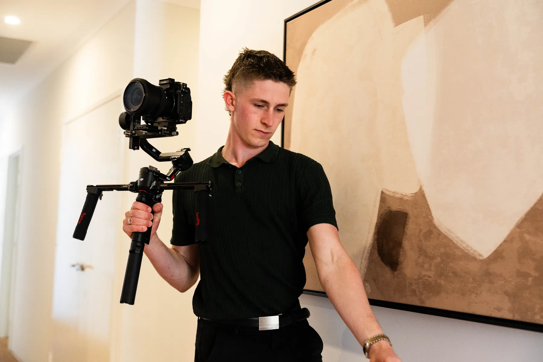 Keoni Upton operating a gimbal in a Perth home during a brand shoot.