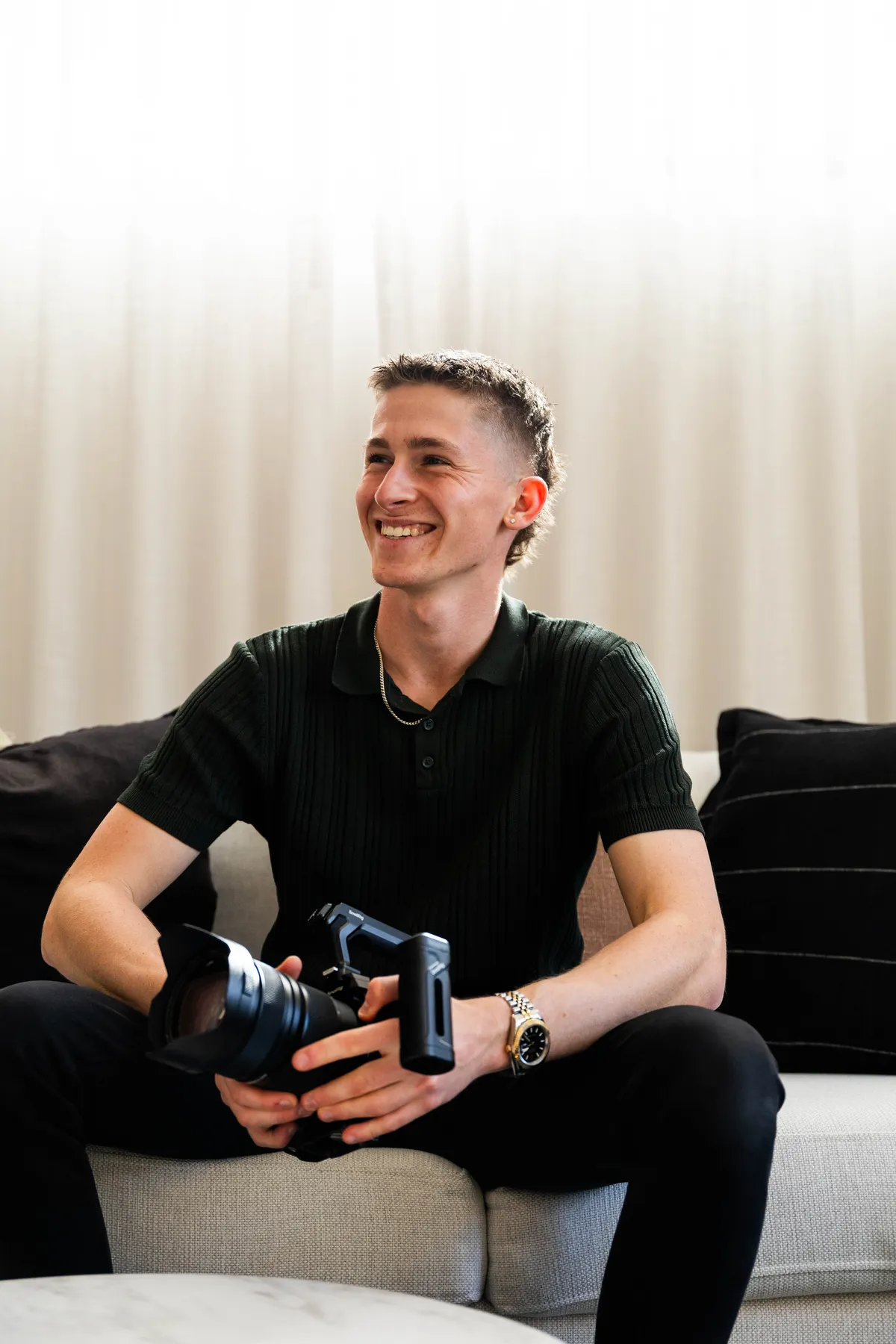 Keoni Upton, Perth videographer and founder of Growth Concept Media, sitting with a cinema camera.