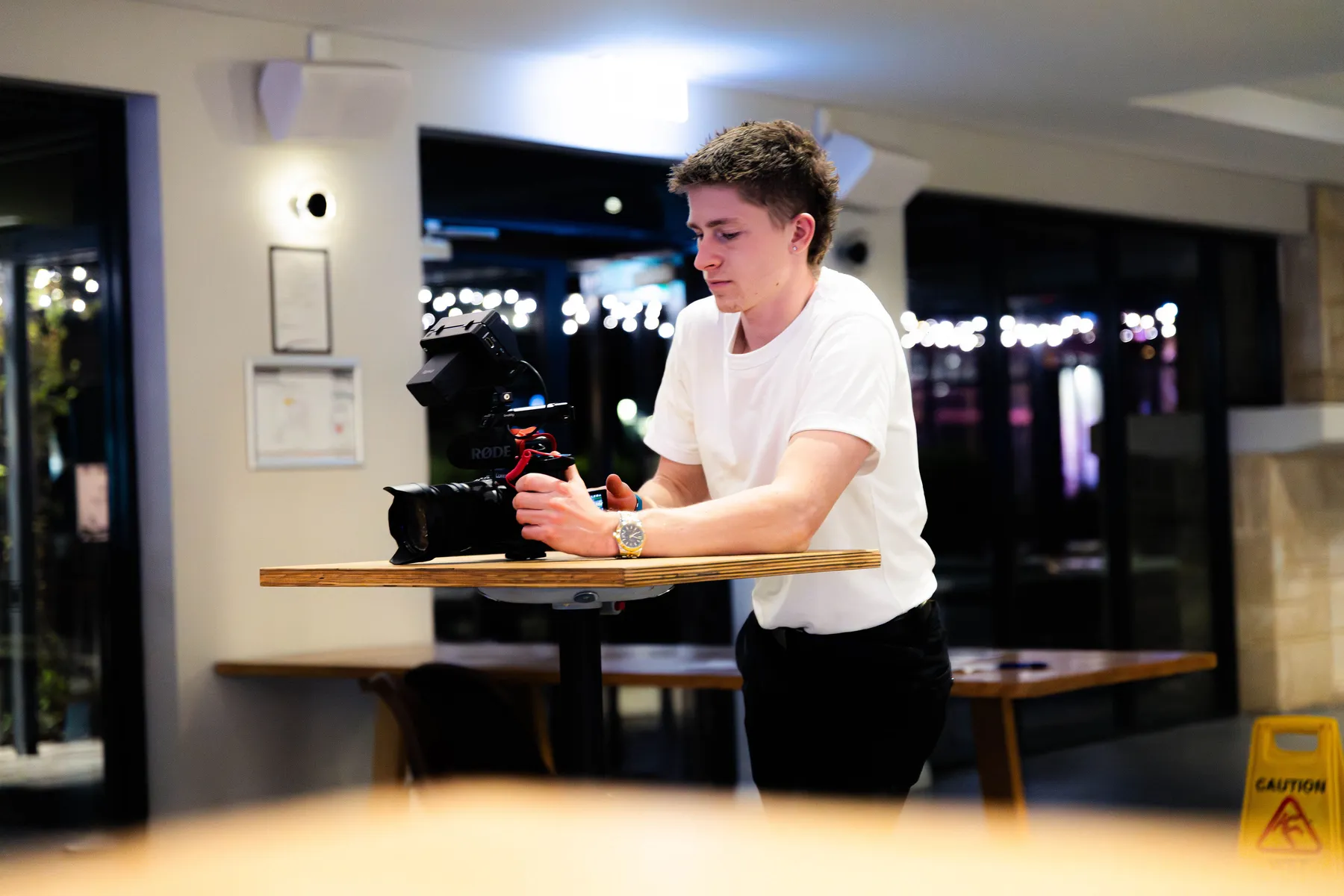 Keoni Upton reviewing a shot at a table on a Perth shoot.