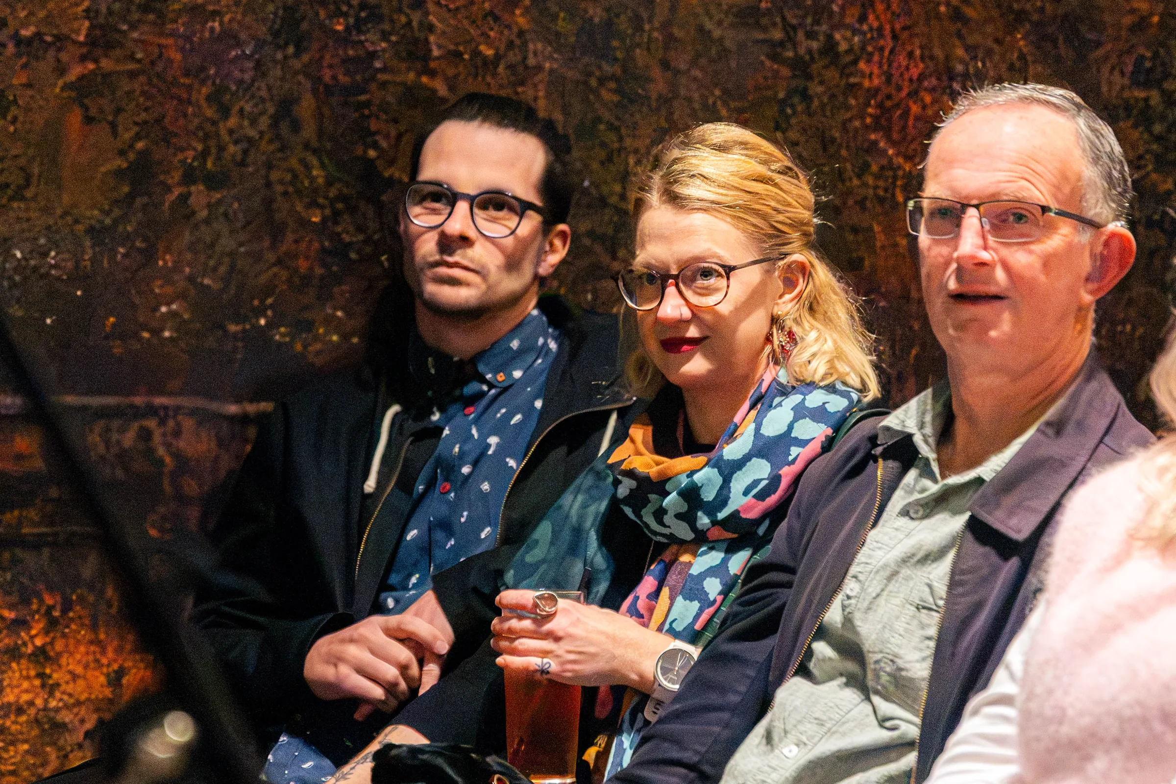 Three guests seated together at a Perth event, photographed by Growth Concept Media.