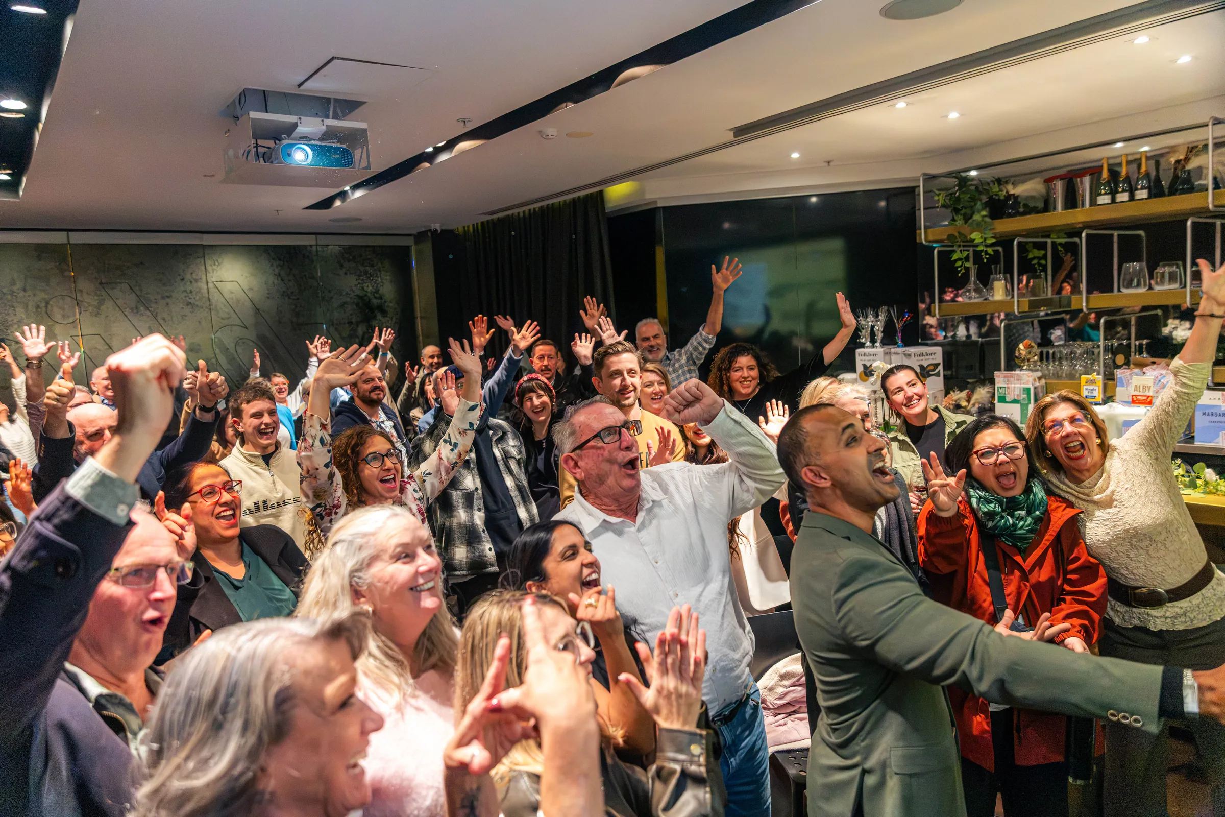 A Perth event audience on their feet with the host.