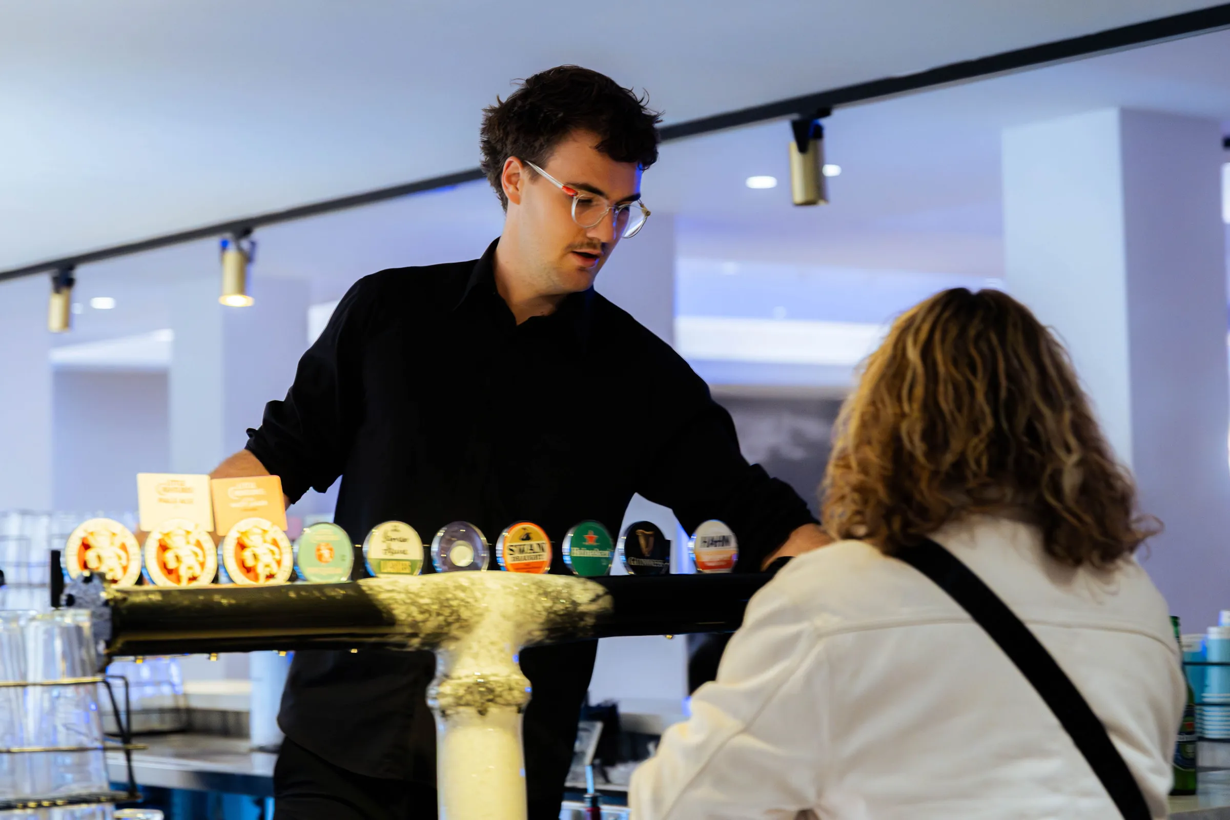 A bartender serving a guest at the Armed For Life quiz night at The Hall, The Camfield, Burswood, photographed by Growth Concept Media.