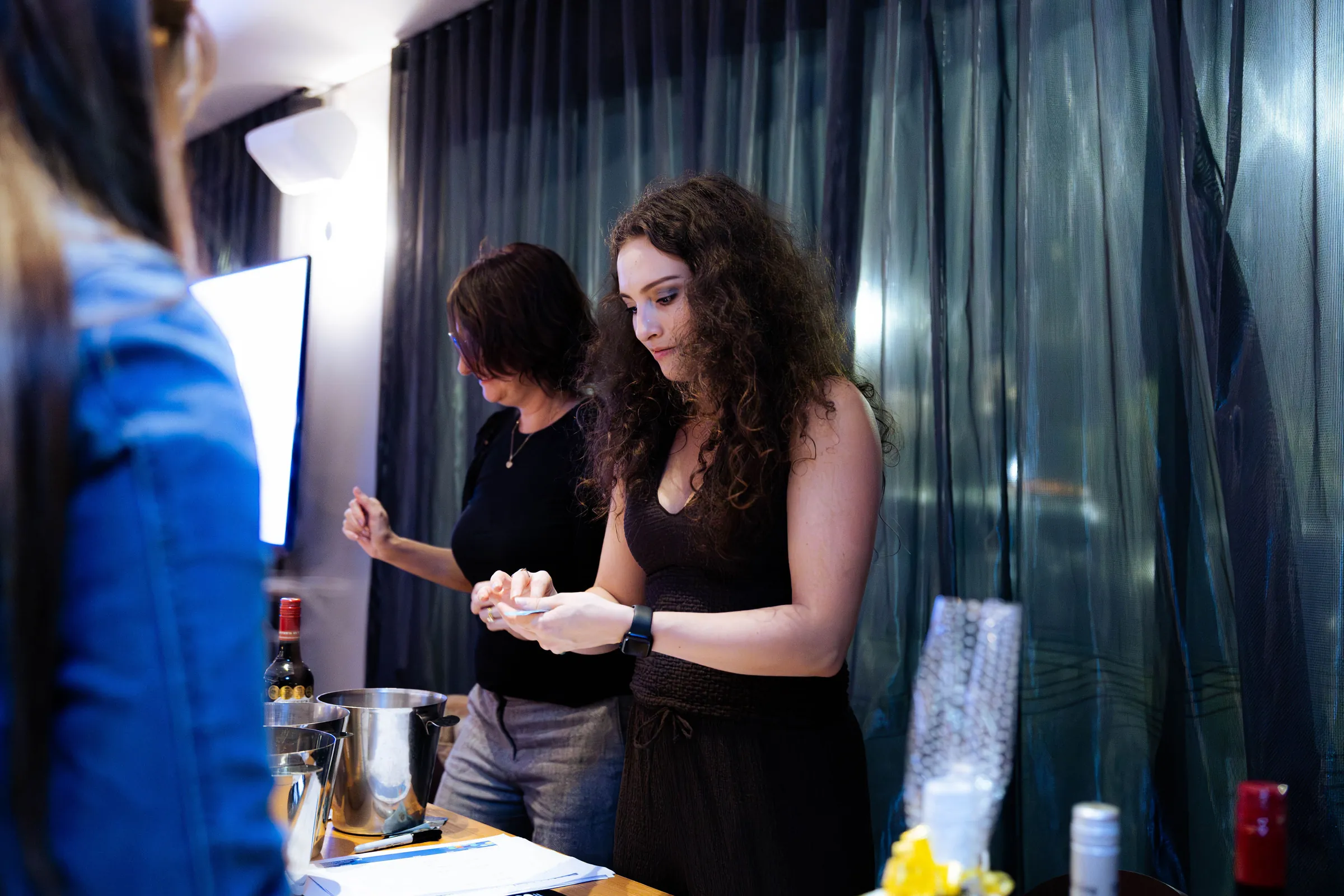 Staff preparing at a table during the Armed For Life quiz night at The Hall, The Camfield, Burswood.