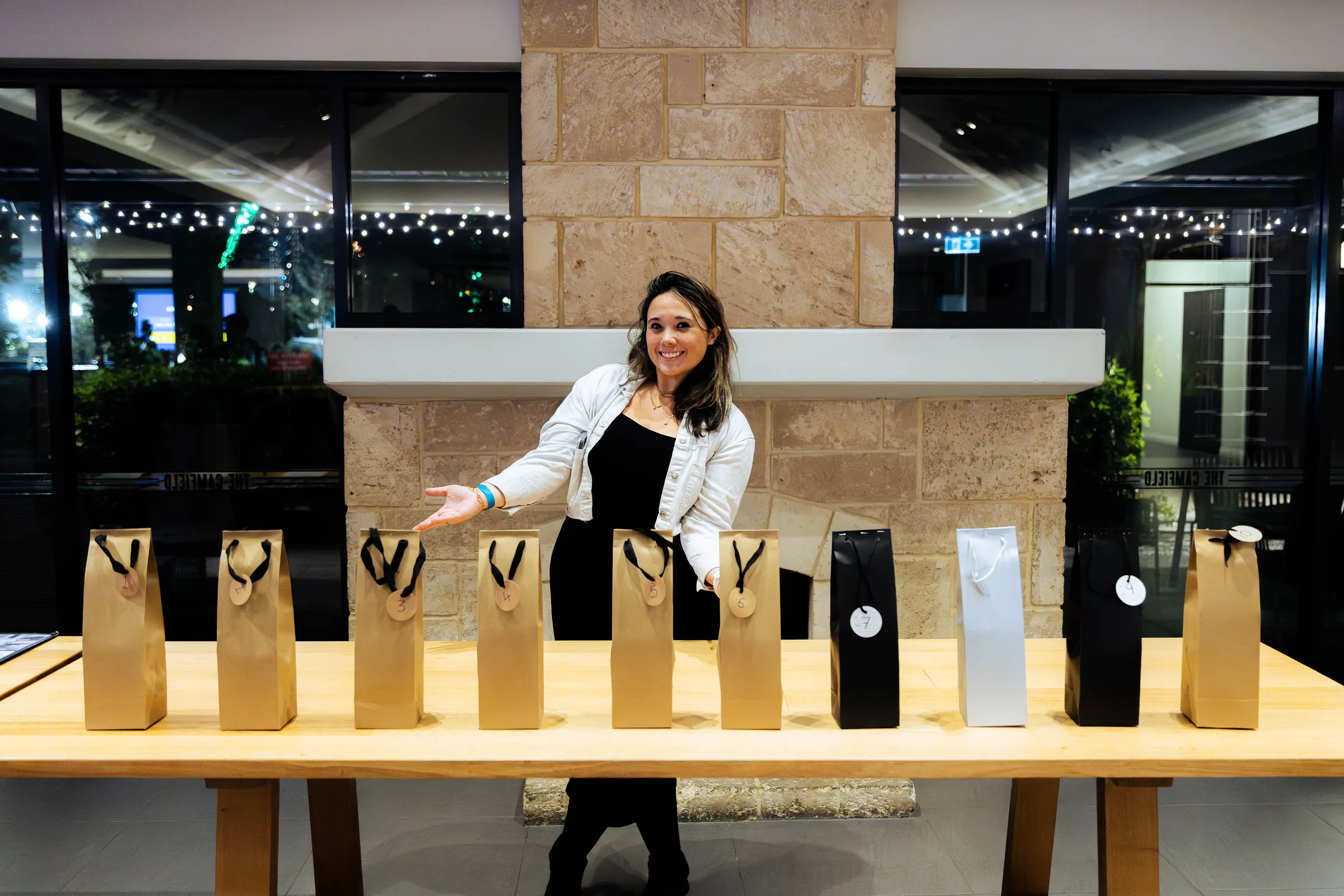A guest presenting gift bags at the Armed For Life quiz night at The Hall, The Camfield, Burswood.