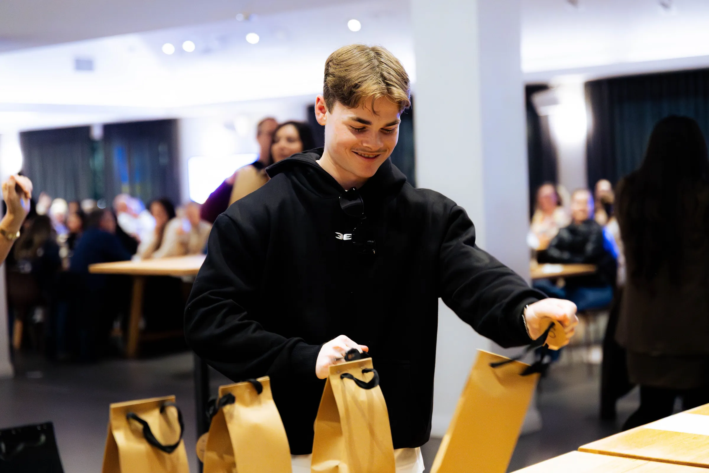 A guest at a Perth event with gift bags, photographed by Growth Concept Media.