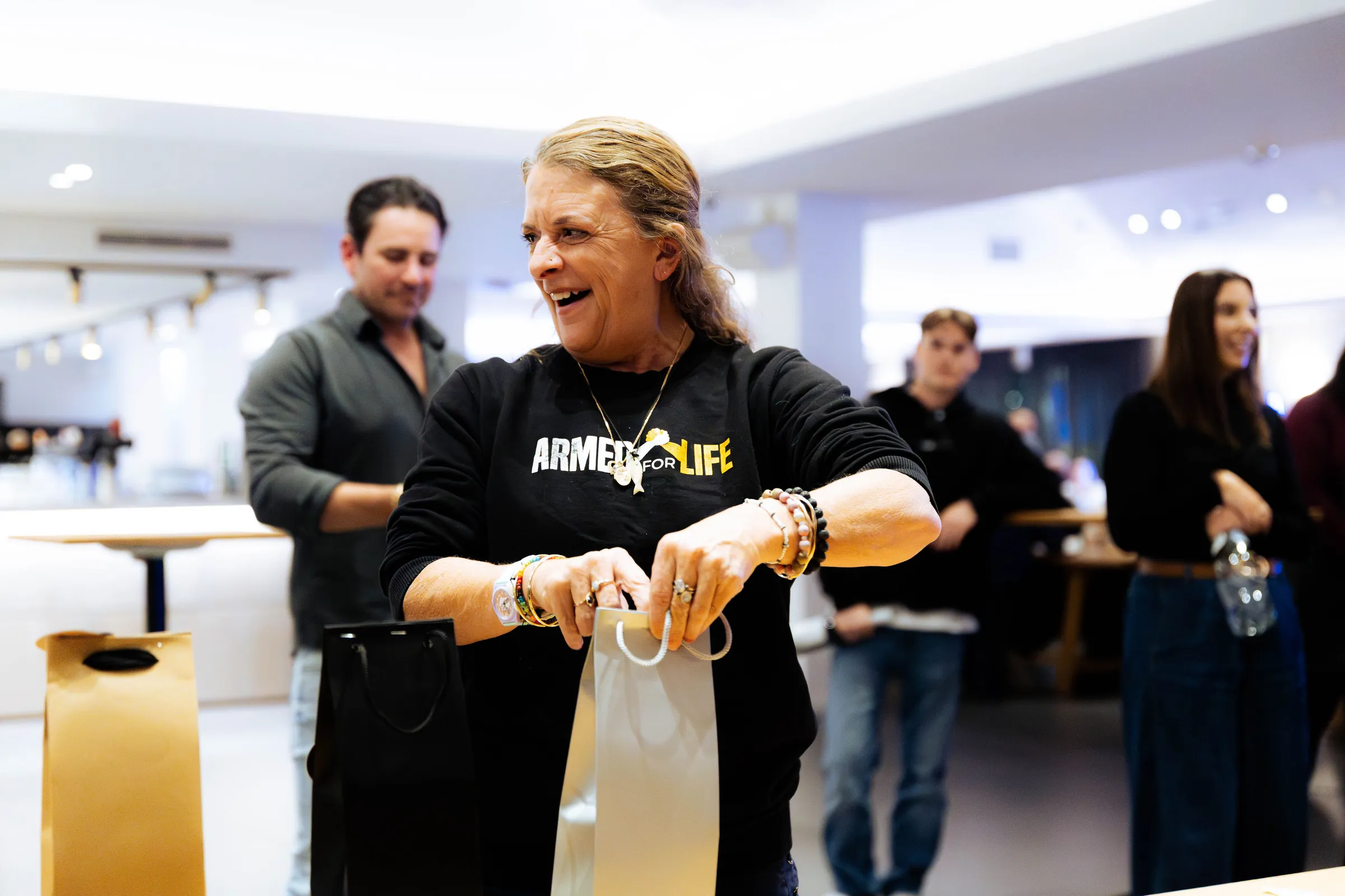A guest in an Armed For Life shirt holding a gift bag at the quiz night at The Hall, The Camfield, Burswood.
