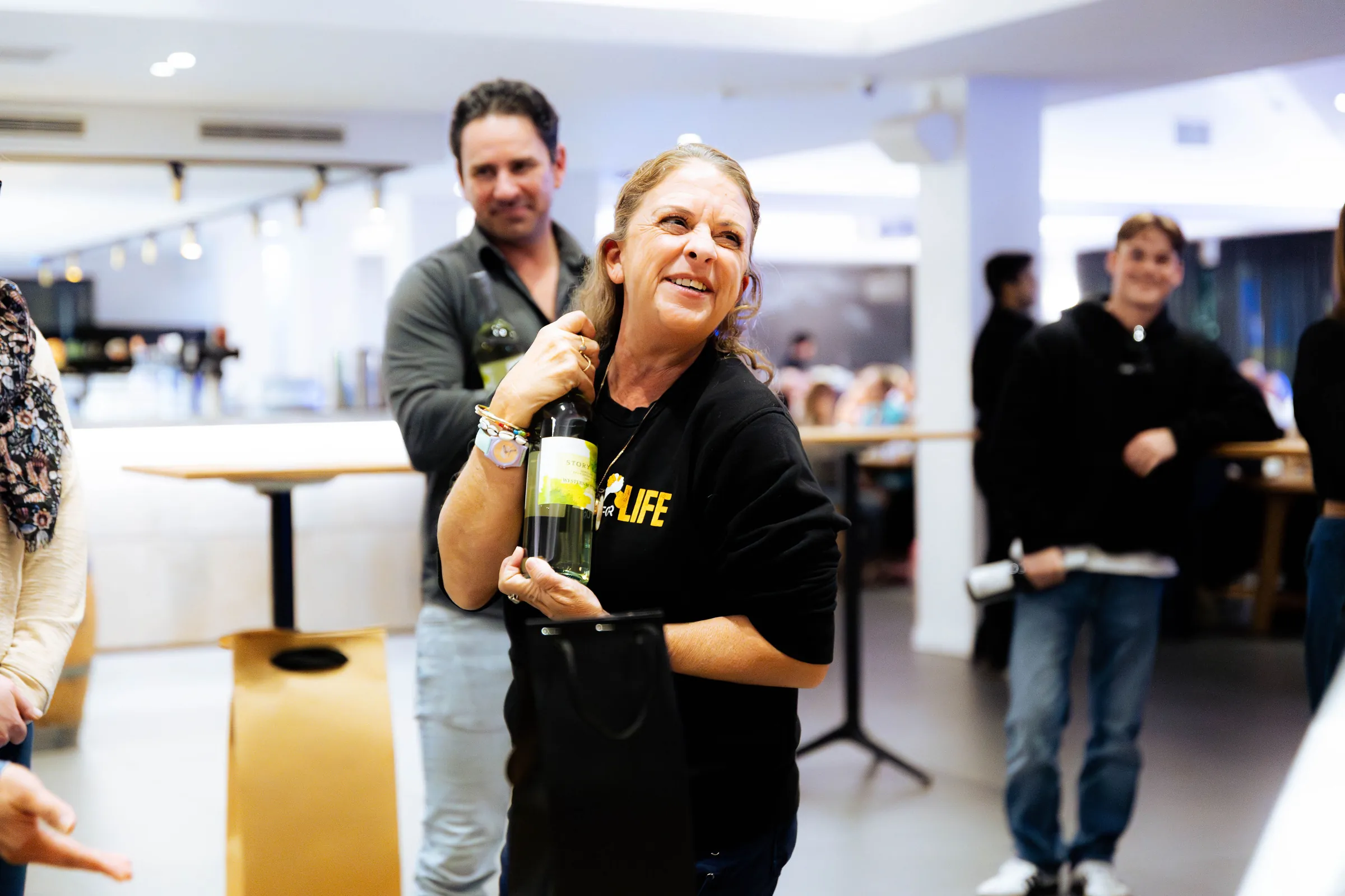 A guest in an Armed For Life shirt holding a bottle at the quiz night at The Hall, The Camfield, Burswood.