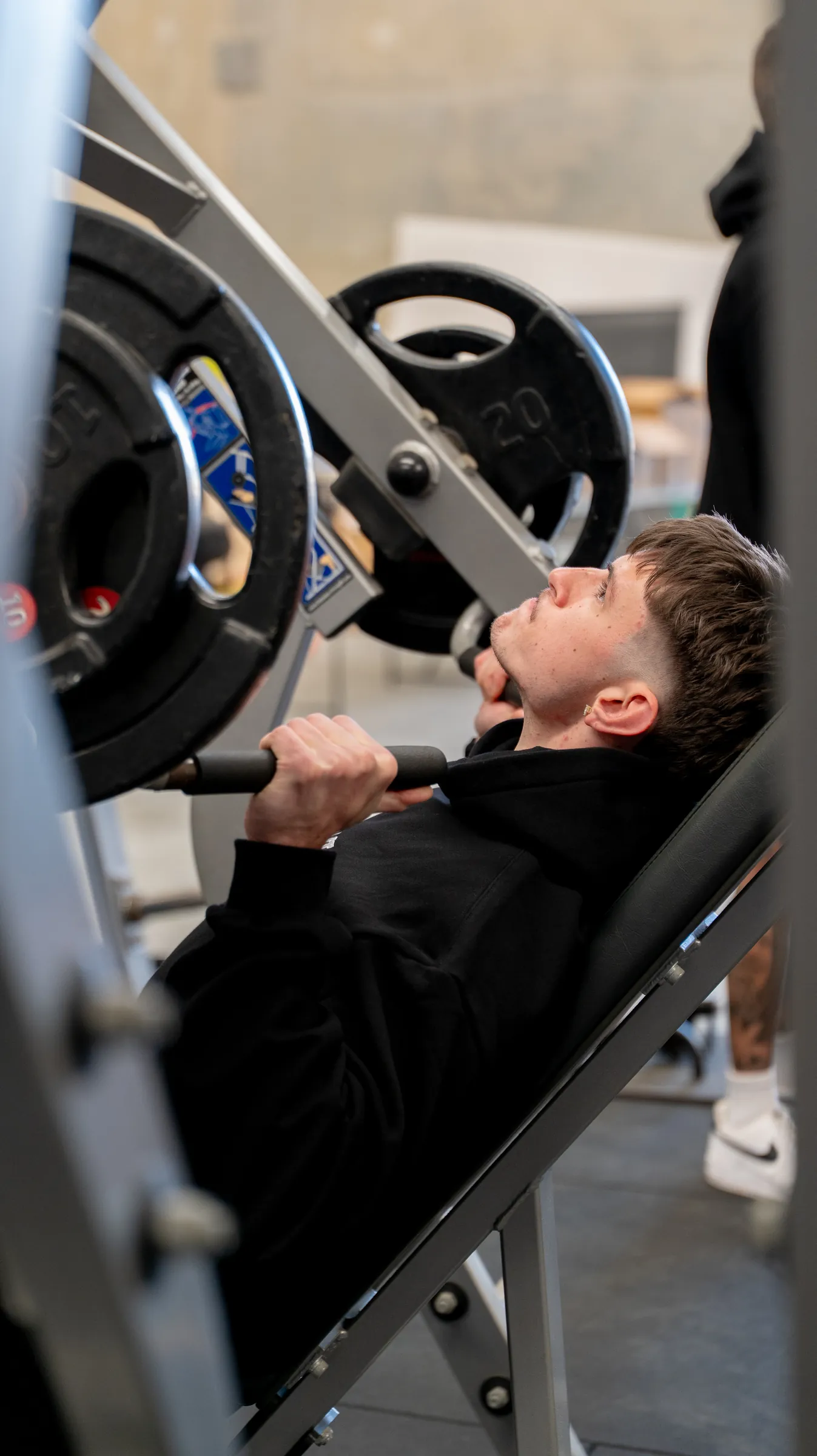 A young man on an incline press in a Perth gym, photographed by Growth Concept Media.