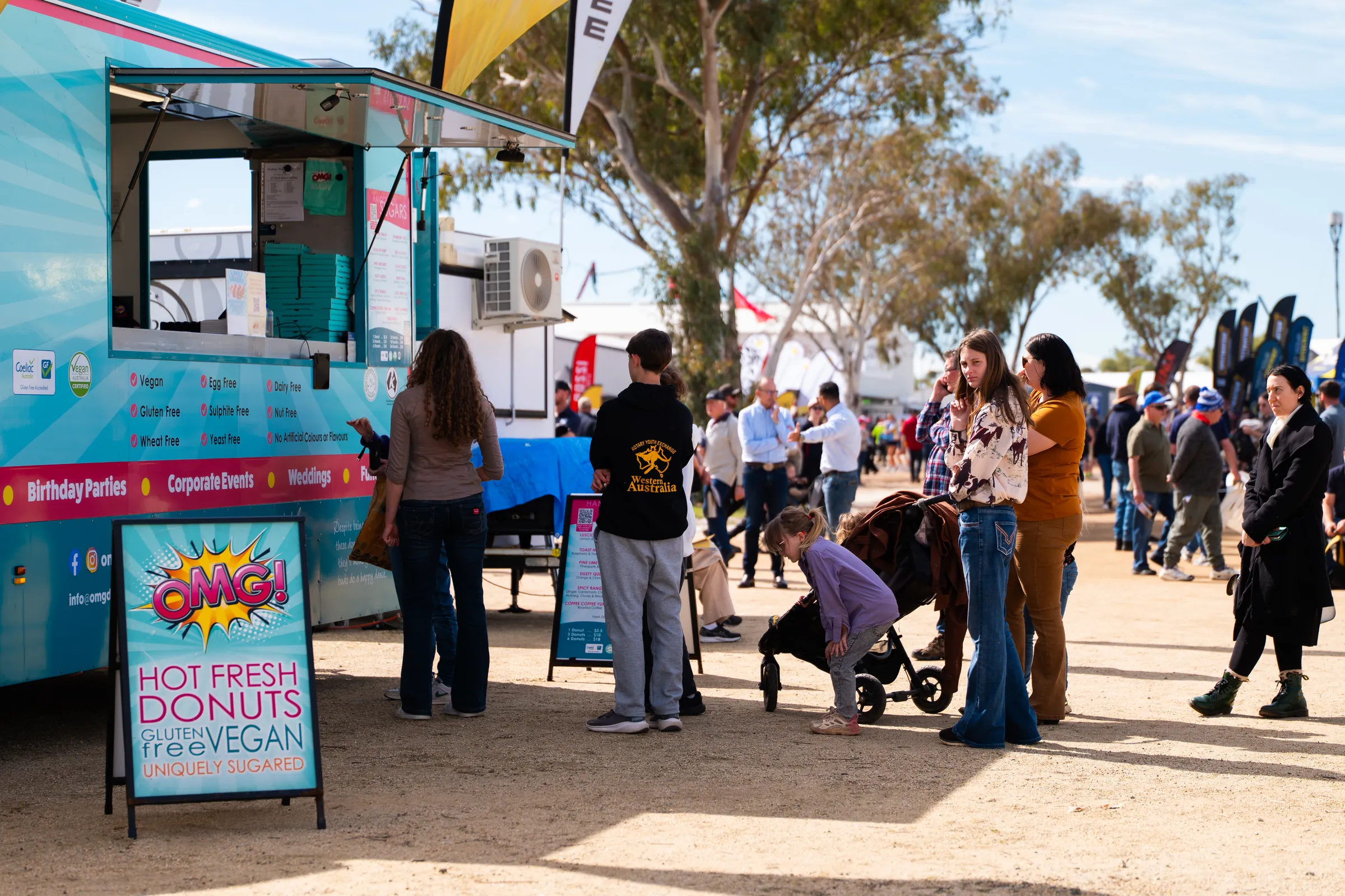 People at a food van at an outdoor event, photographed by Growth Concept Media.