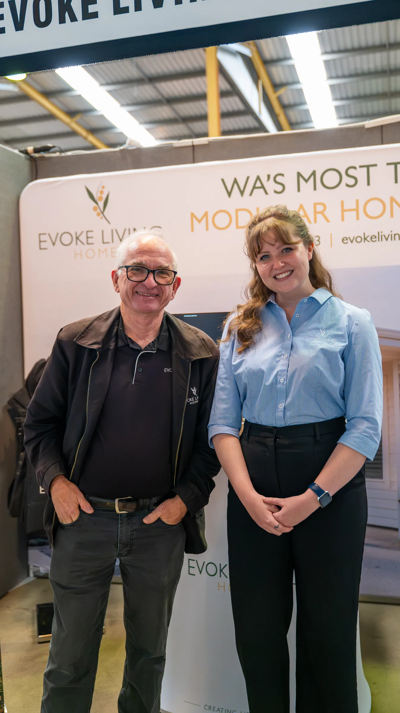Two people at the Evoke Living stand, photographed by Growth Concept Media.