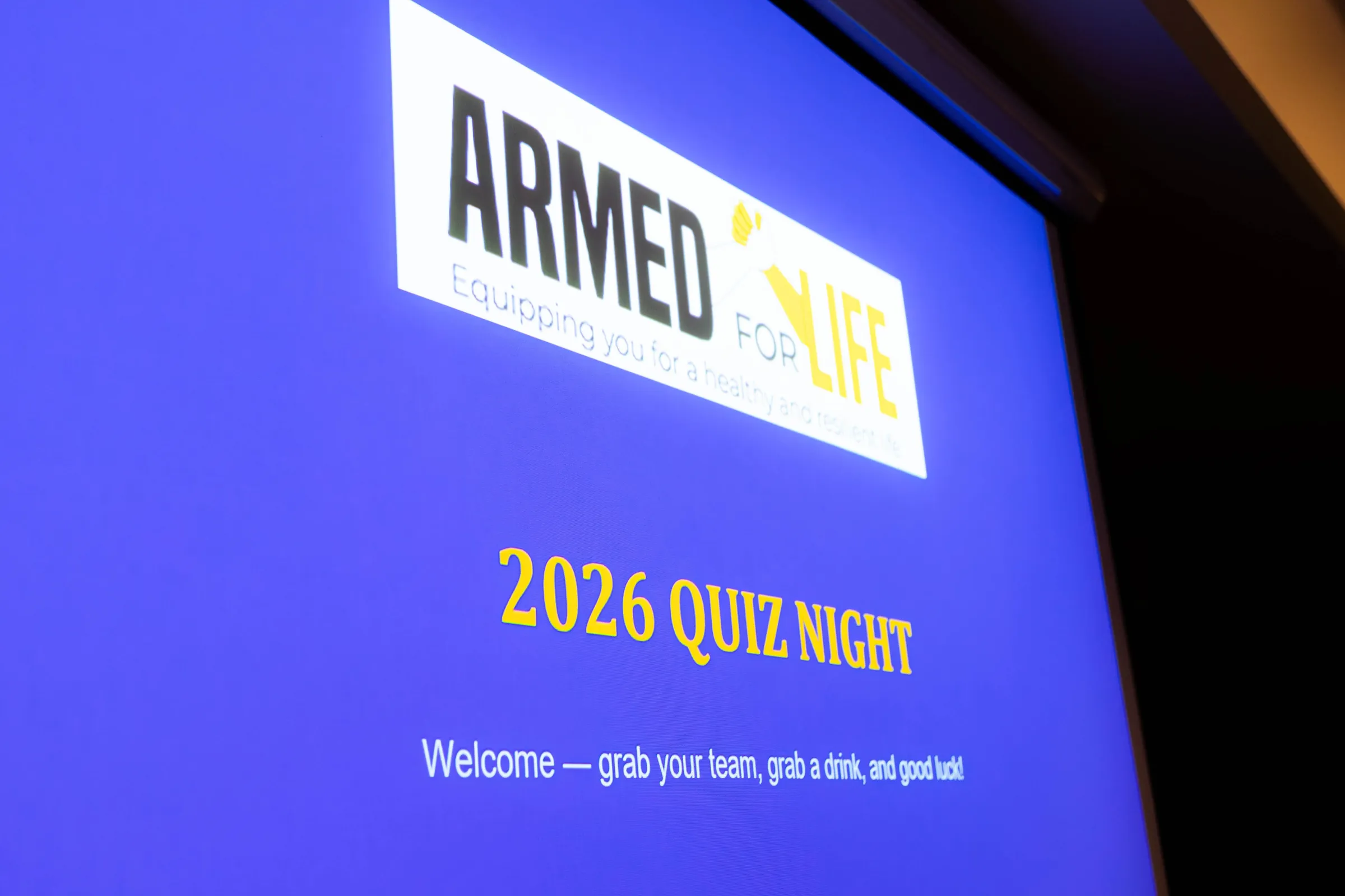 Welcome slide at the Armed For Life quiz night at The Hall, The Camfield, Burswood, photographed by Growth Concept Media.