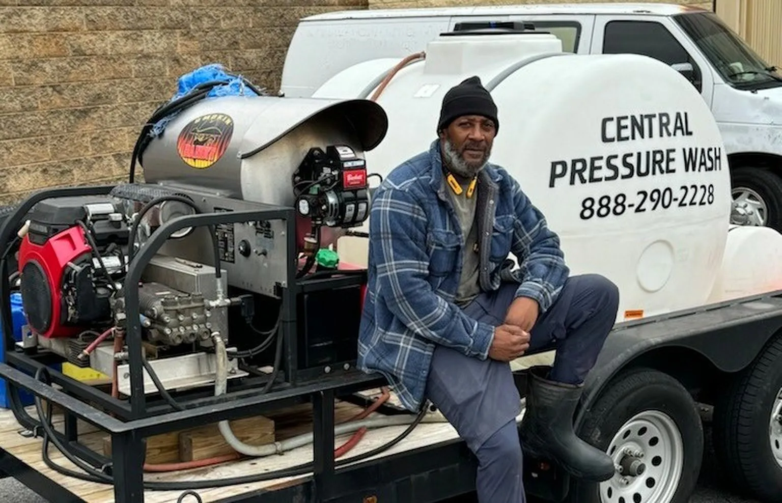 Arthur Gray, Jr., owner of Central Pressure Wash, seated on his hot-water pressure washing rig in Atlanta
