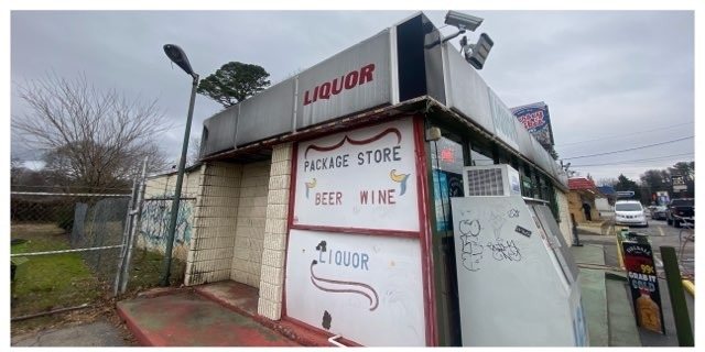 Storefront corner wall and sign with grime before commercial washing