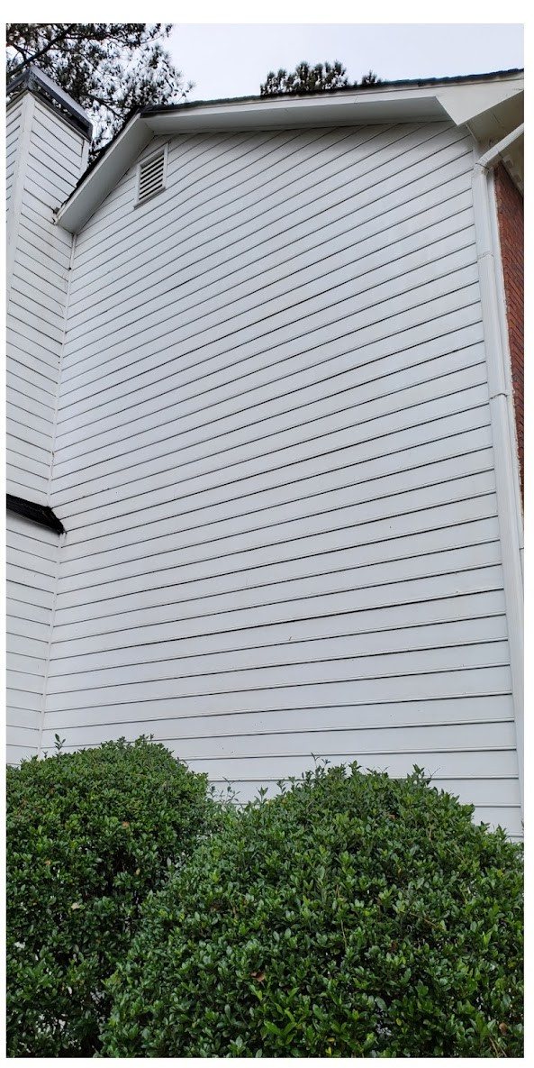 The same white vinyl siding bright and clean after a soft wash