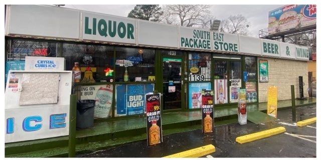 Package store storefront and sidewalk dirty before commercial pressure washing