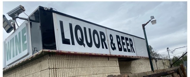 The same building sign and wall clean after commercial washing