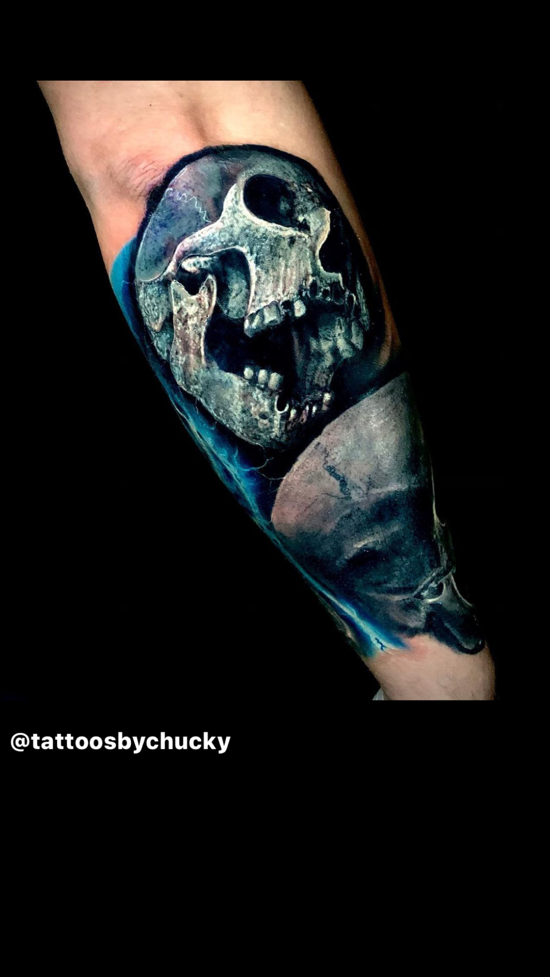 Color realism blue skull forearm tattoo by Chucky Holden.