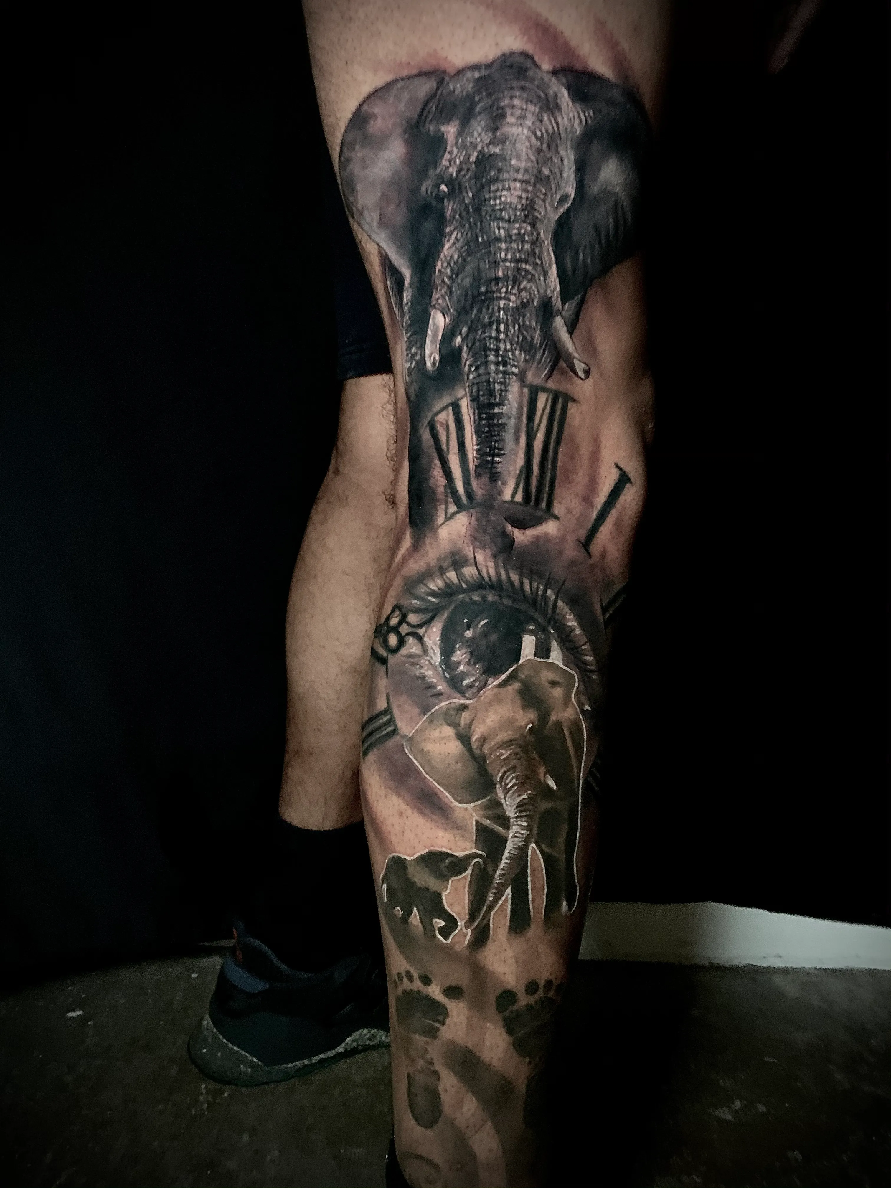 Elephant and clock black and grey leg tattoo by Chucky Holden in Arlington, Texas
