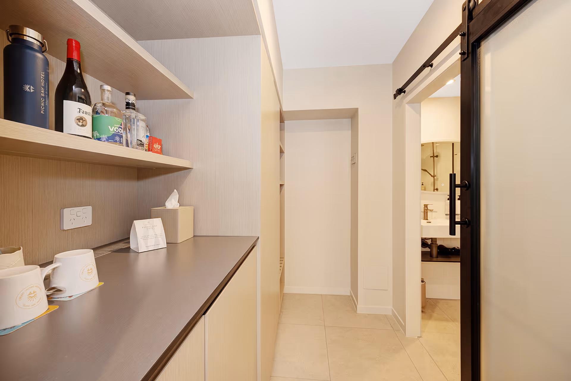 The mini bar shelf and hallway through to the bathroom in the Garden Queen Room.