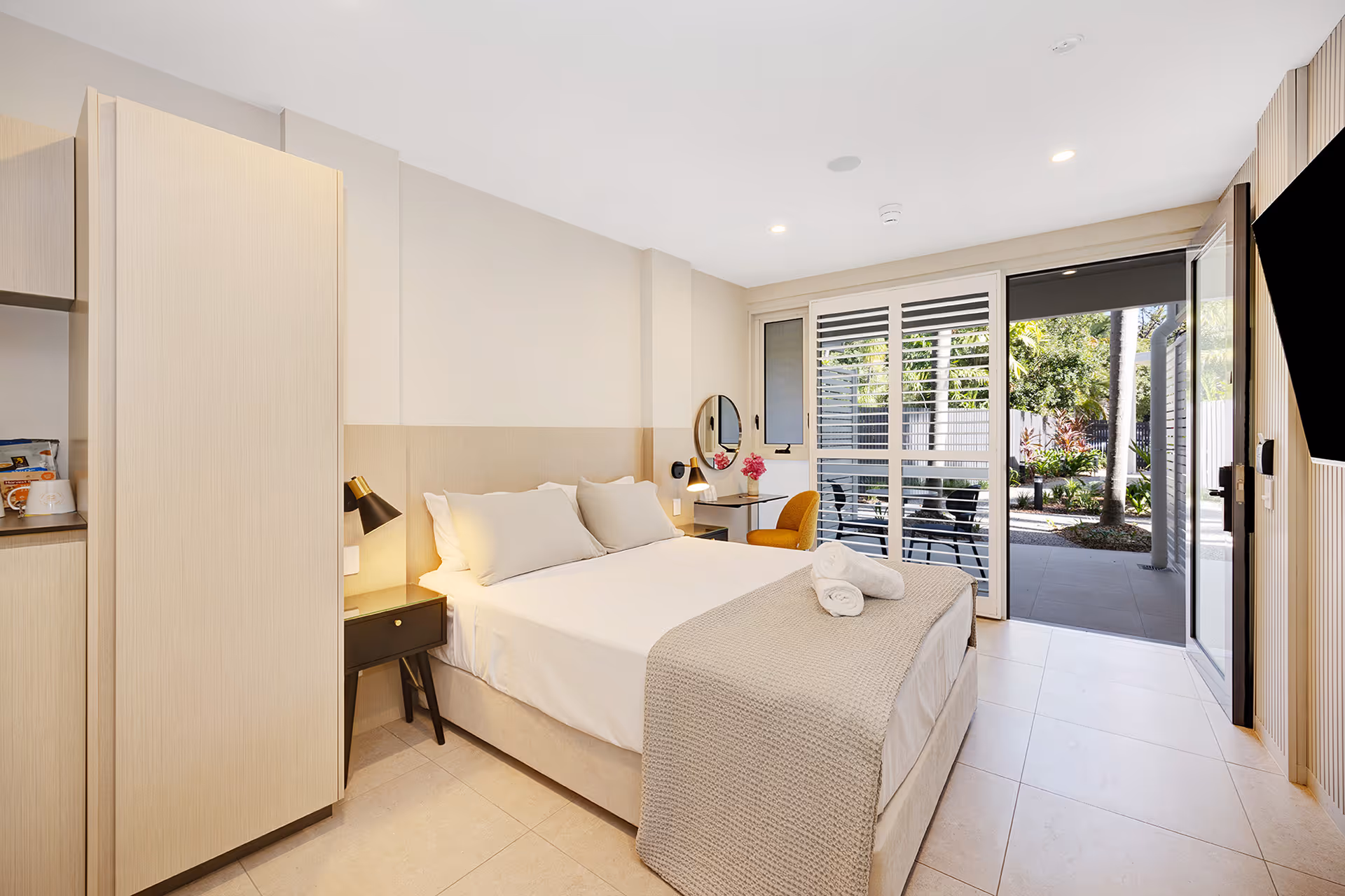 The Garden Accessible Room, with a queen bed and sliding doors open to the terrace.