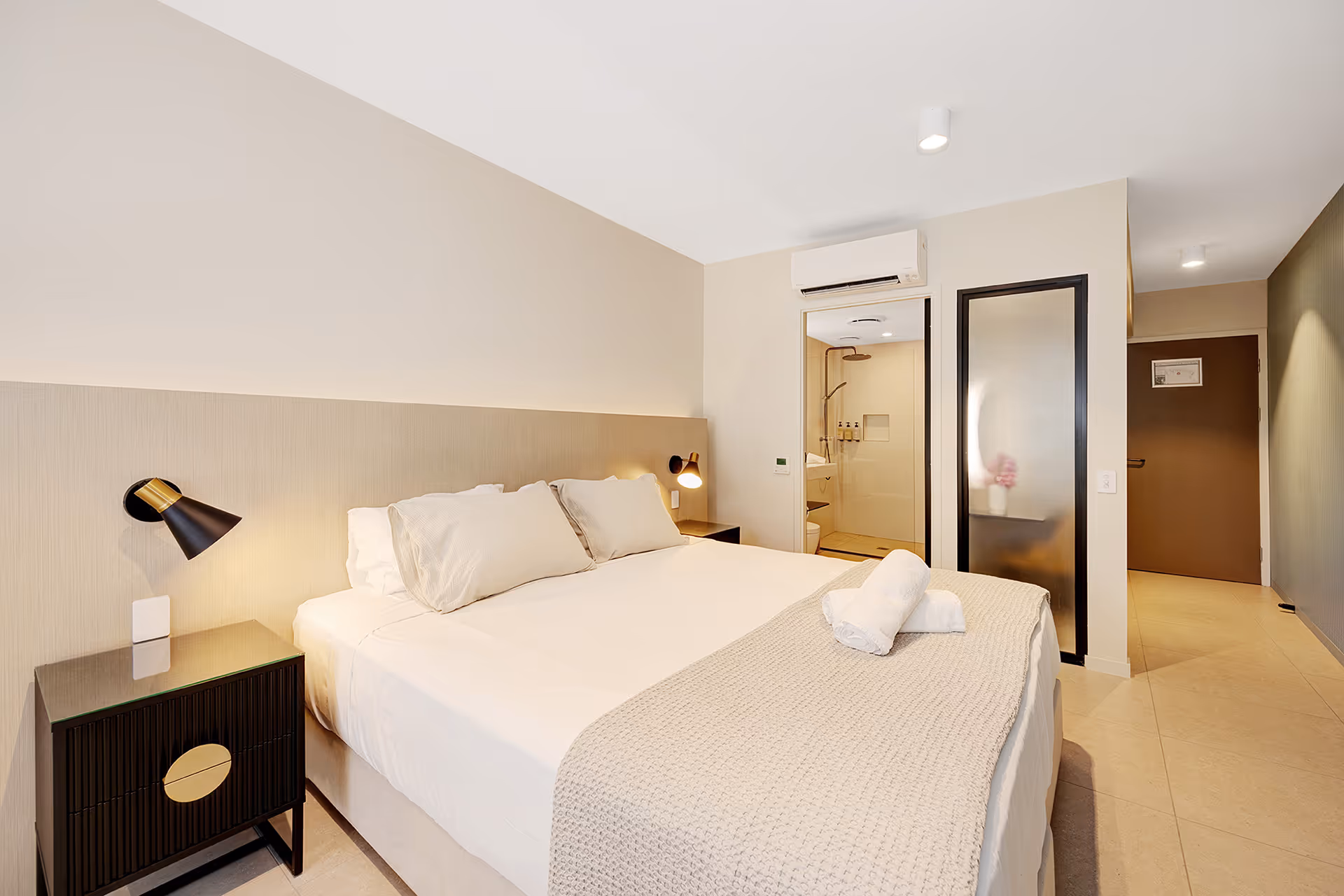 The king bed in the Garden View Superior Room, with the ensuite beyond.