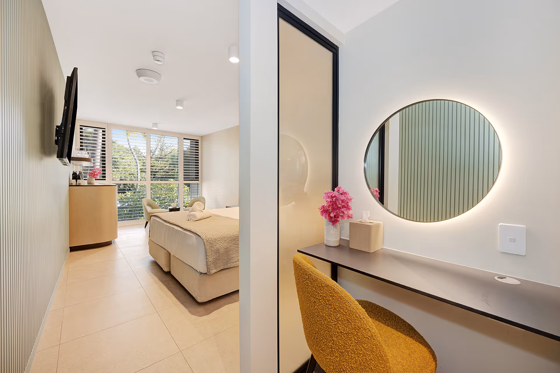 The desk and mirror in the Garden View Superior Room, looking through to the bed.