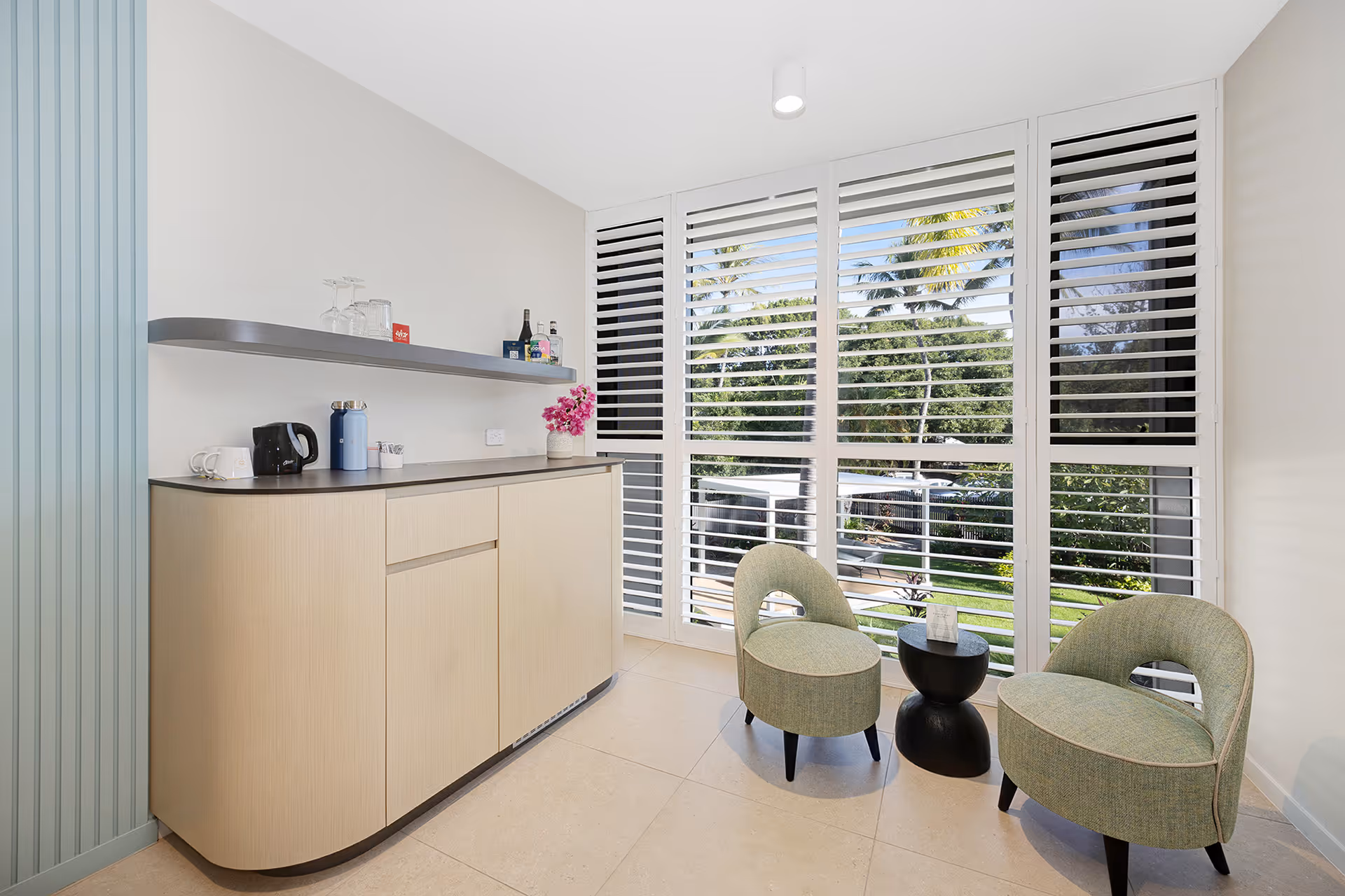 The kitchenette in the Garden View Superior Room, beside louvred windows onto the garden.