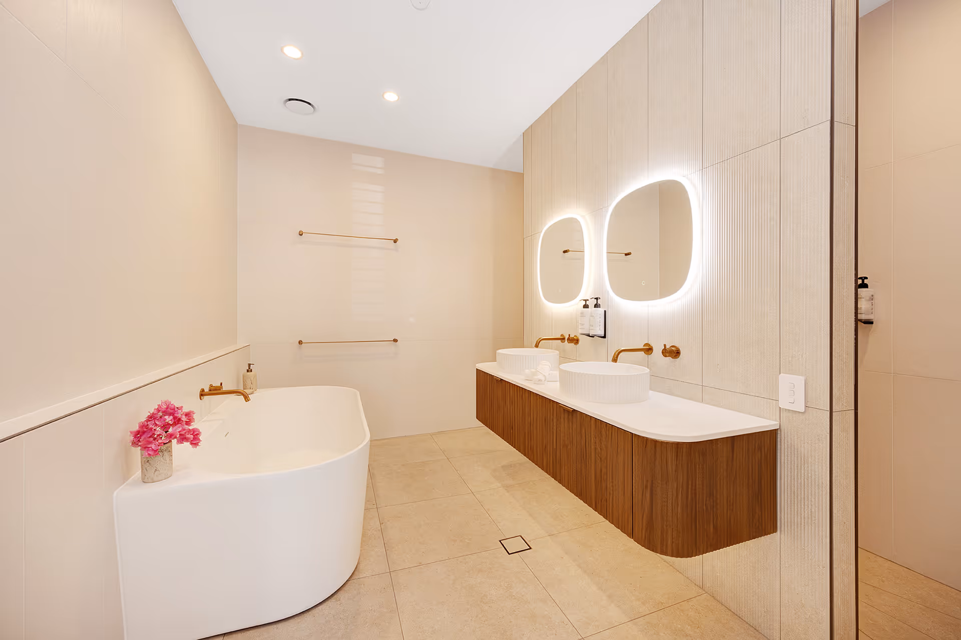 A freestanding bath beside the twin basins in the Executive Suite bathroom.