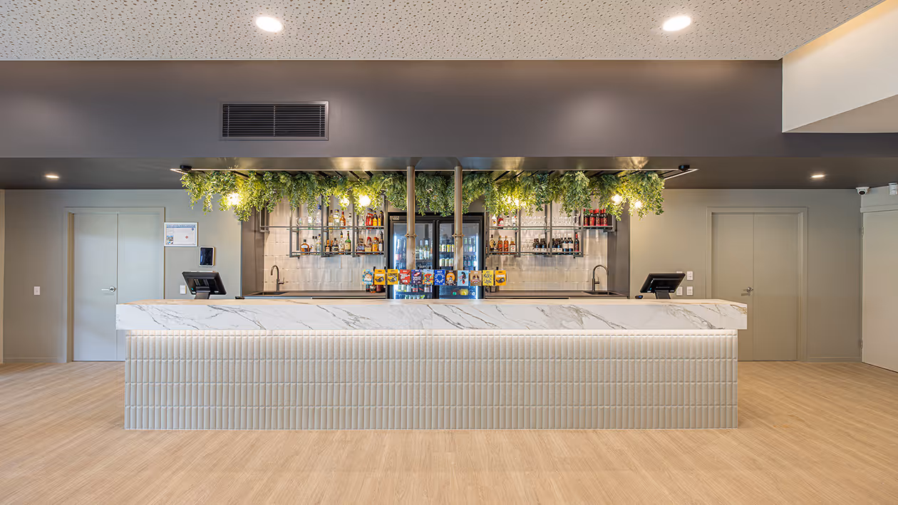 The Public Bar, with its long counter and hanging greenery.
