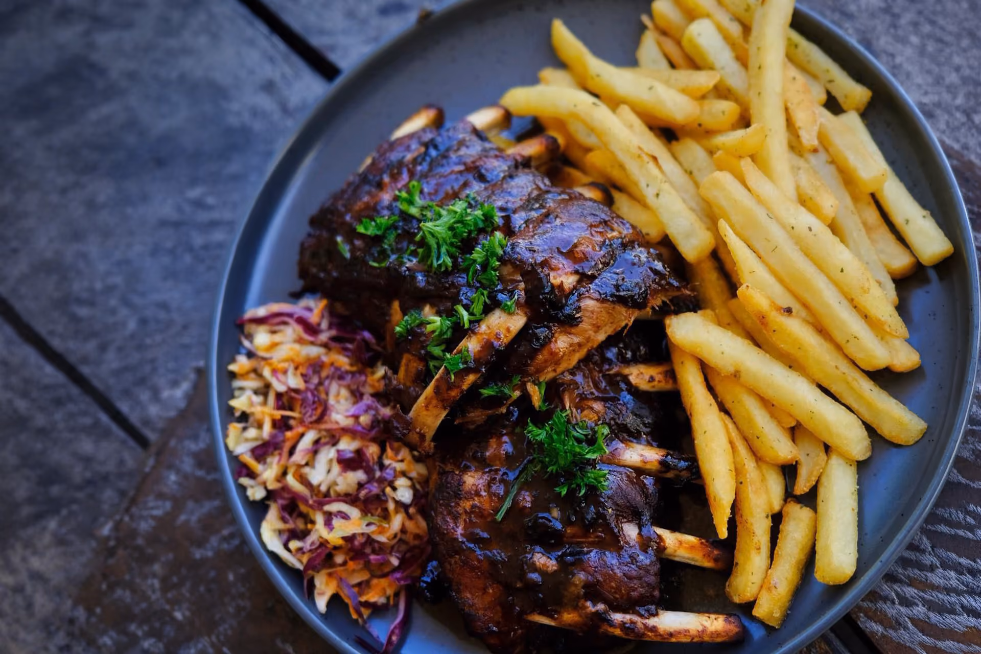 Sticky pork ribs with slaw and chips, served at the R&R Bistro.