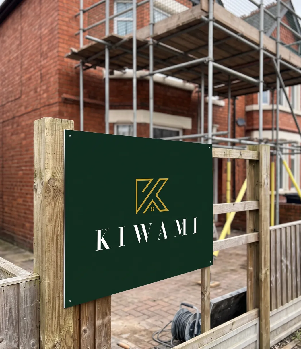 KIWAMI sign on a fence outside a property with scaffolding
