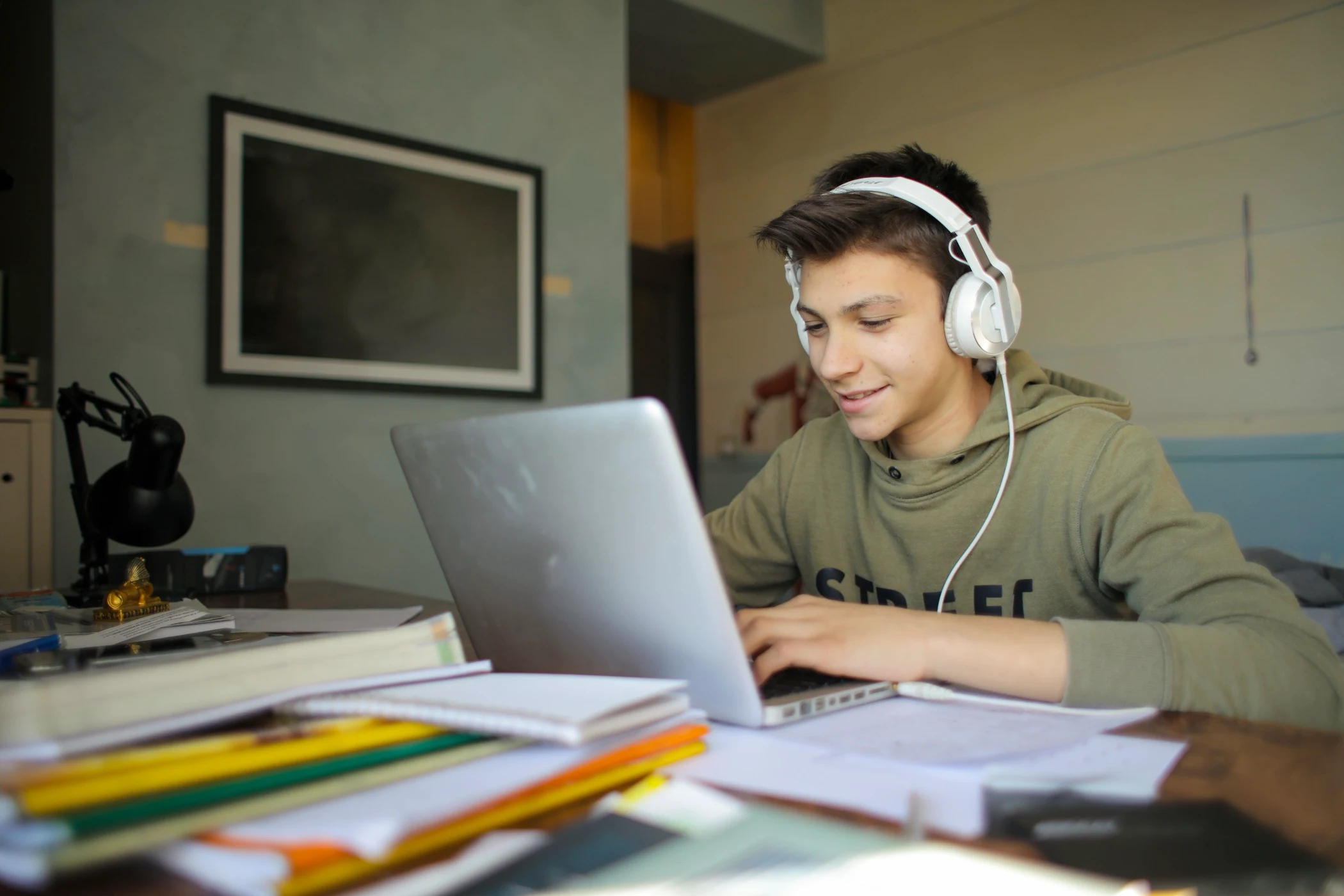 Teenage boy with headphones in an online tutoring session