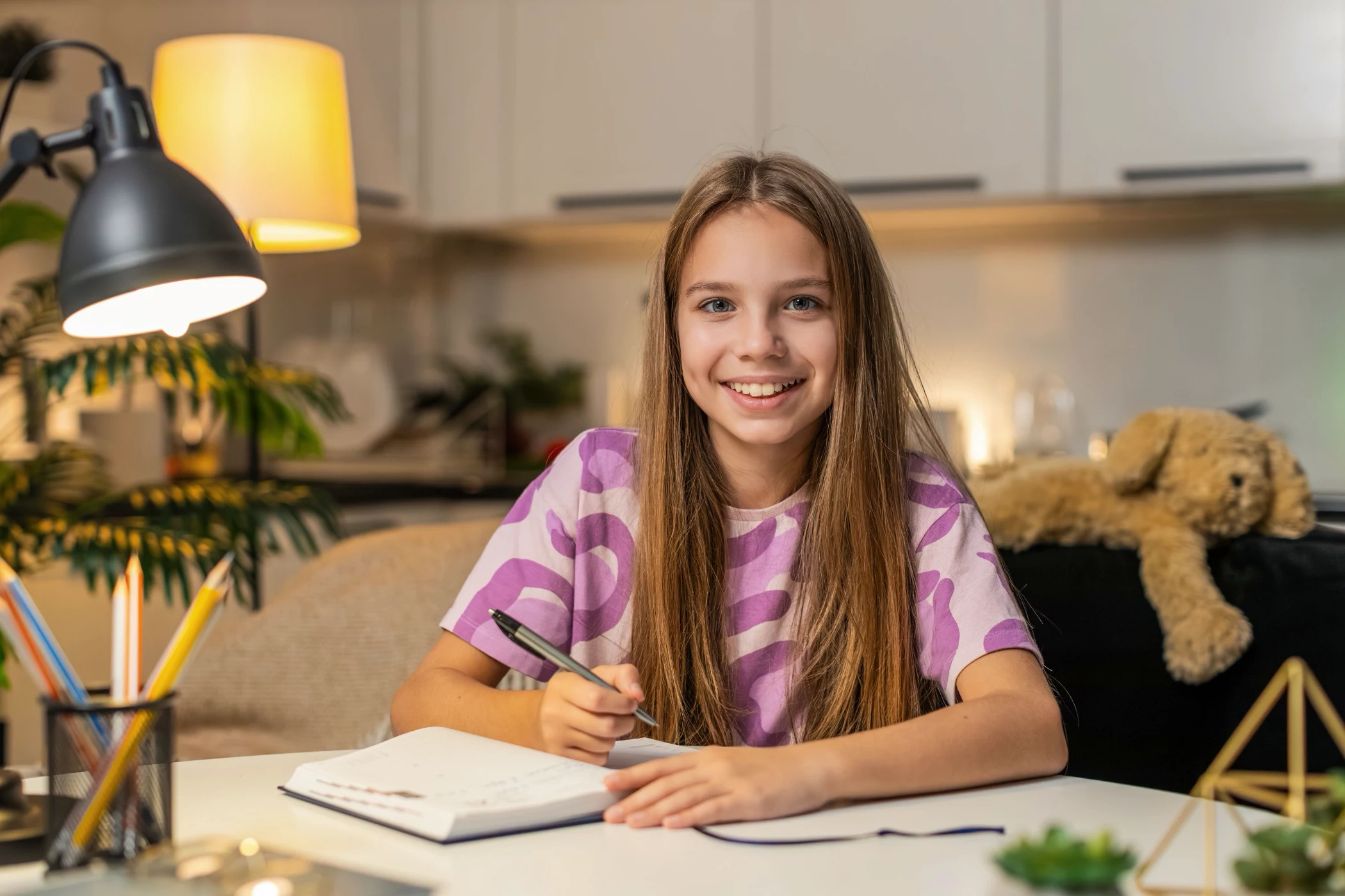 Smiling girl at her desk ready for her tutoring session