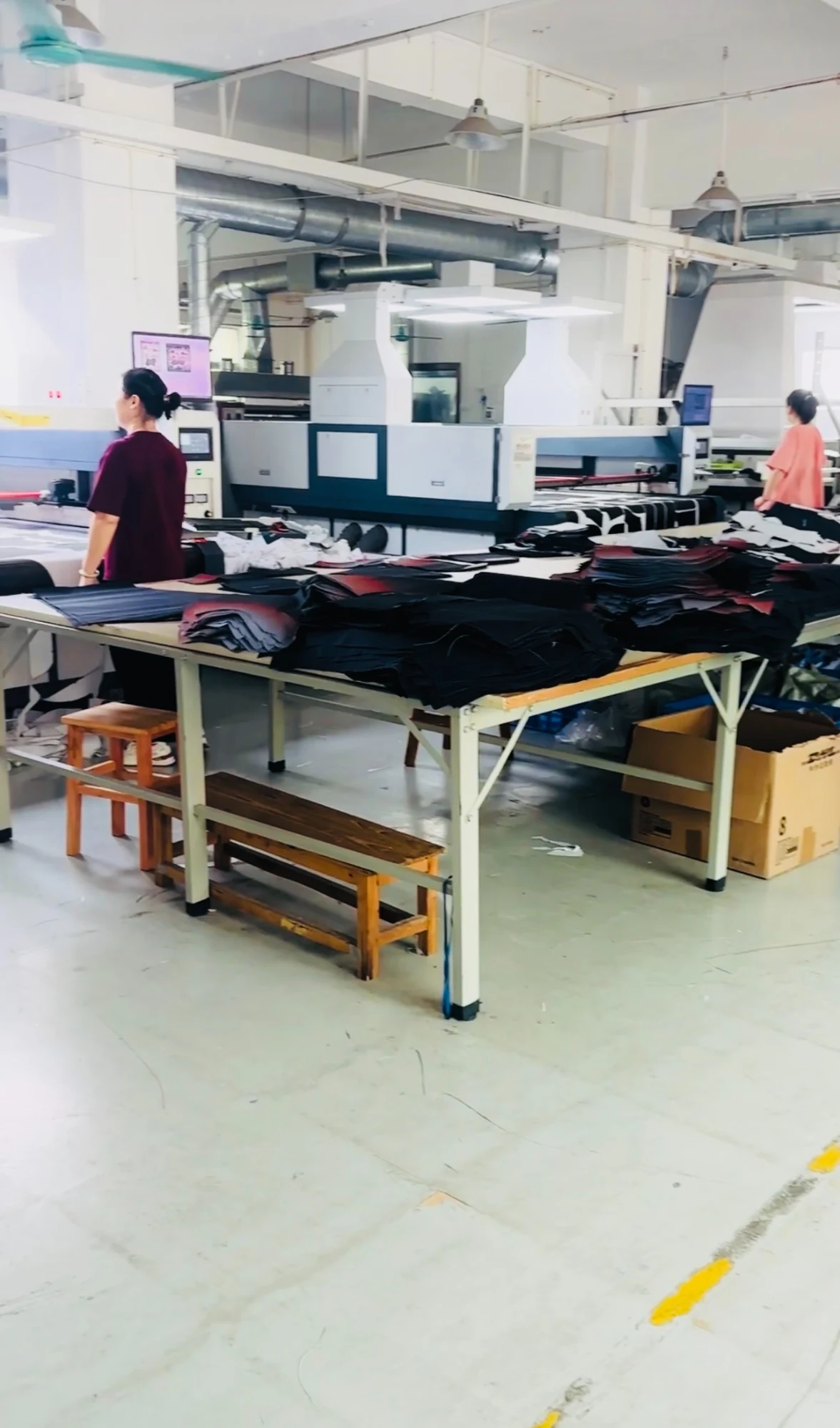 Staff working with cut fabric at the Dongguan production facility