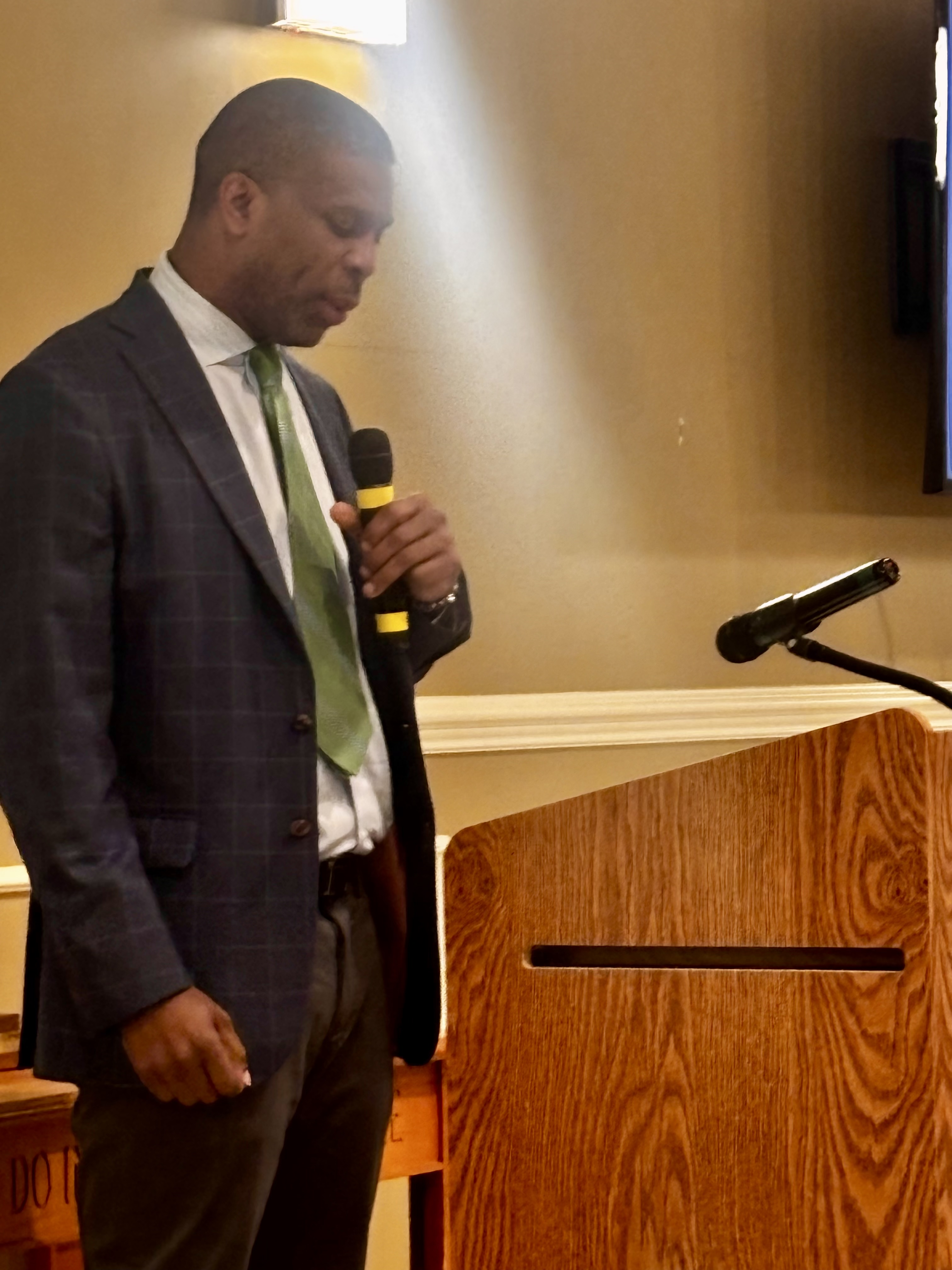 Dr. Christopher Green speaking at a podium