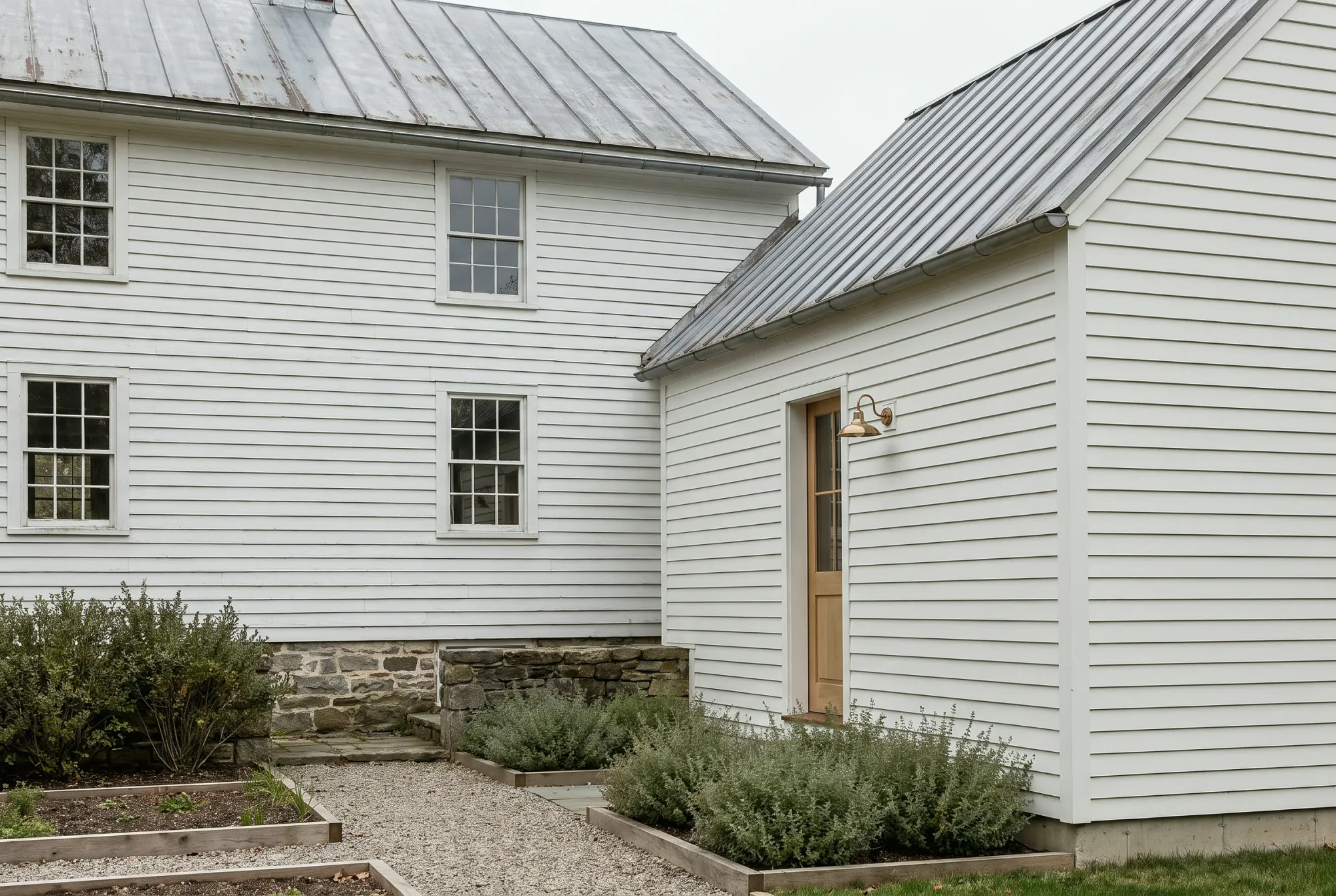A new wing meeting an original clapboard farmhouse, the rooflines aligned