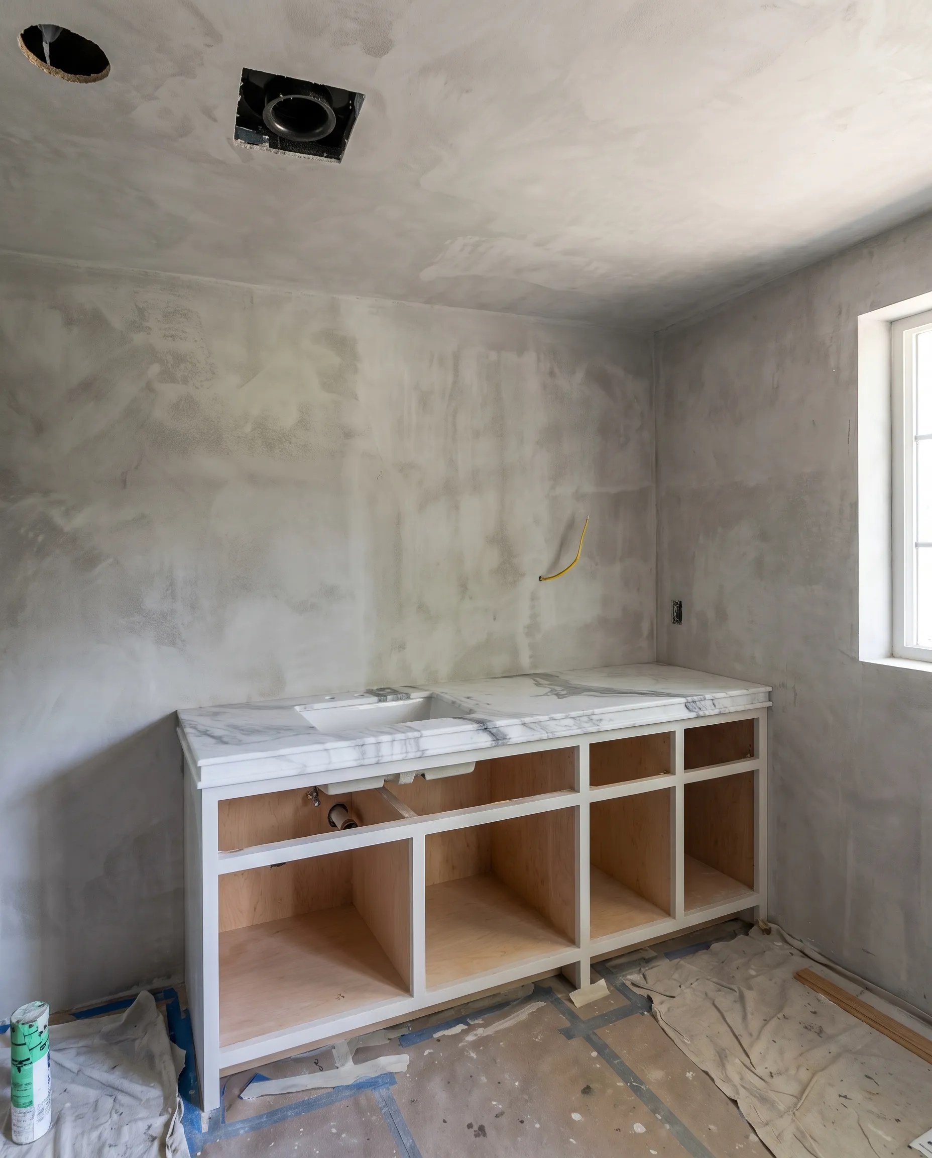 Plaster vanity wall being finished in a bathroom