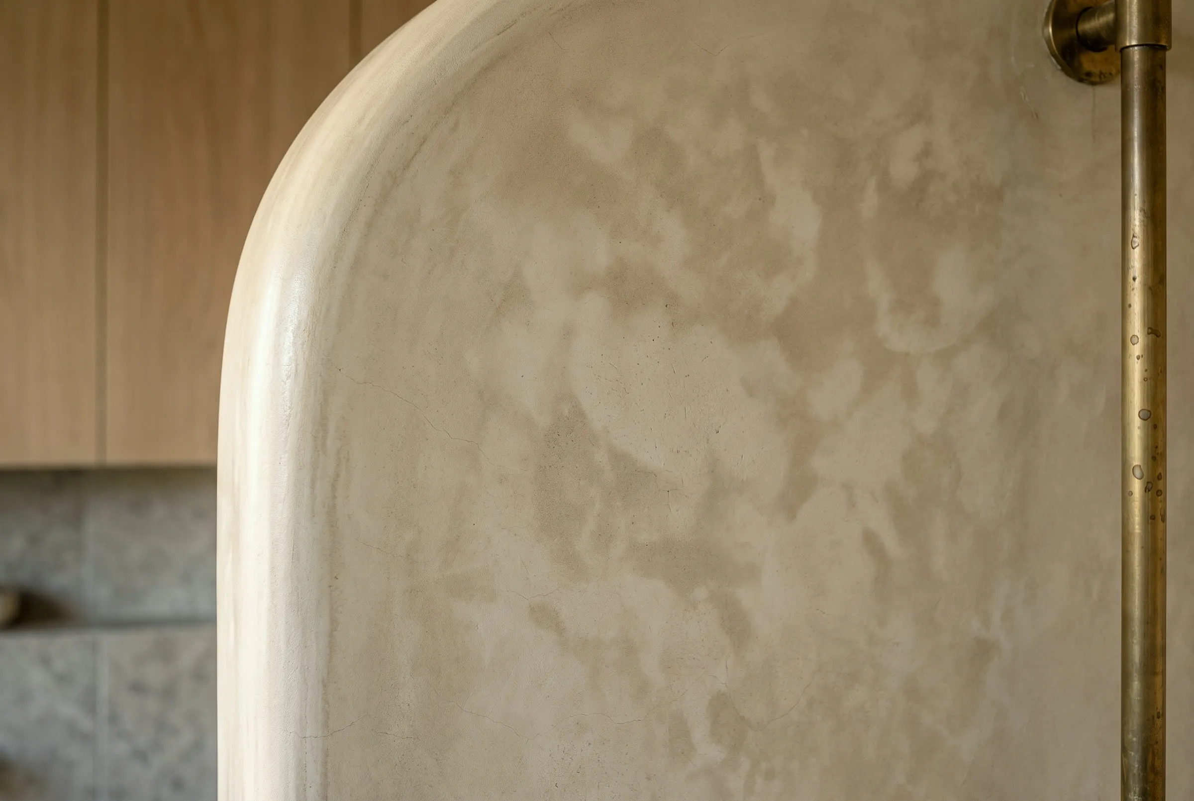 Hand-troweled tadelakt lime plaster wall with a burnished sheen